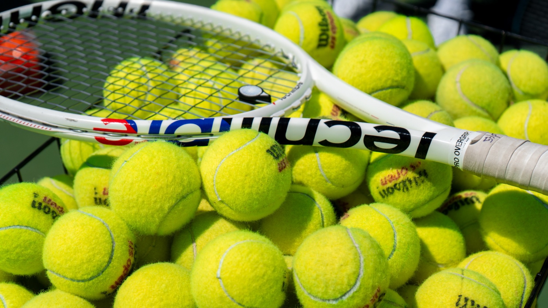 Tennis balls and racquet at a 2026 Kennesaw State men's tennis match.