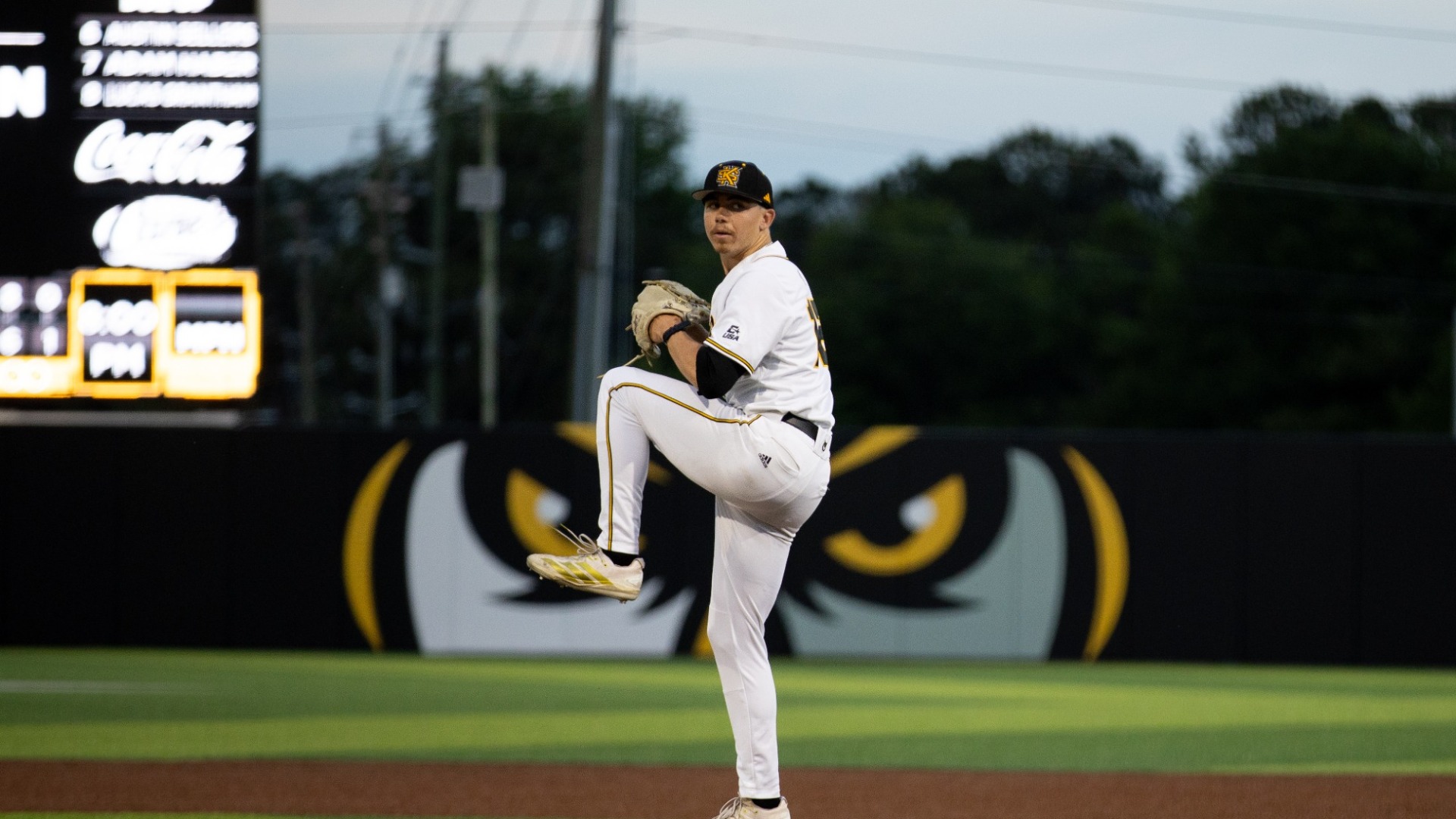 Nate Helman throwing a pitch, wearing all white