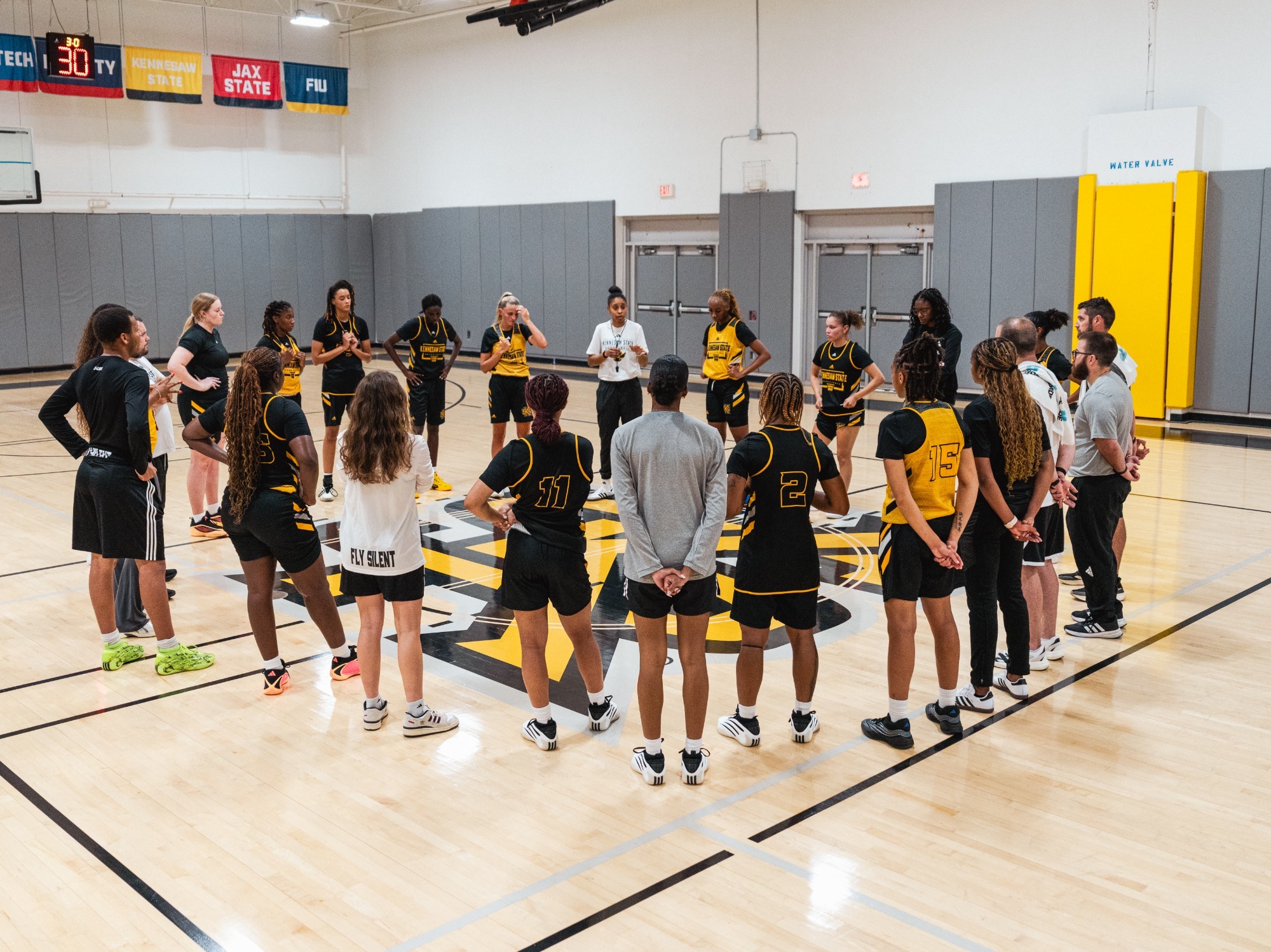 Kennesaw State women's basketball huddles during a summer practice.