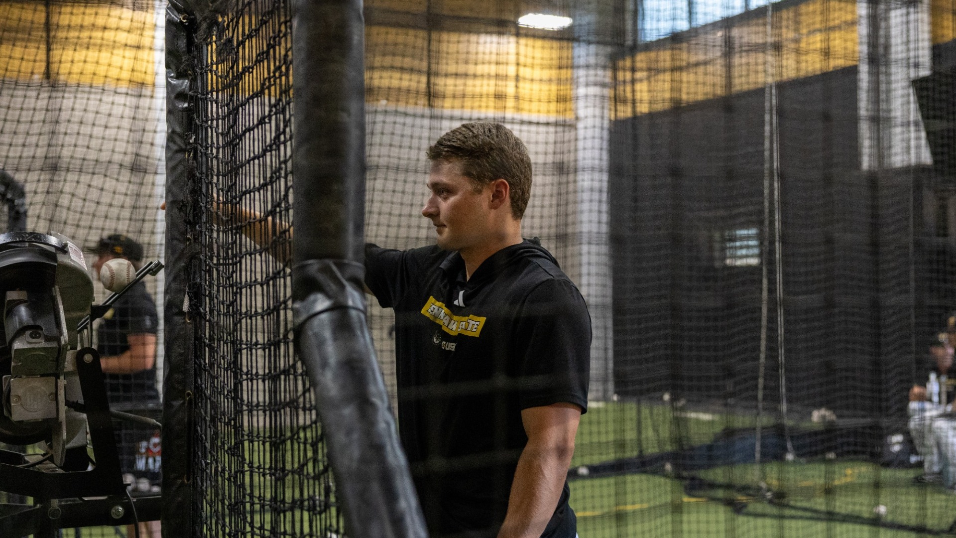 Wade Richardson feeding the pitching machine during batting practice