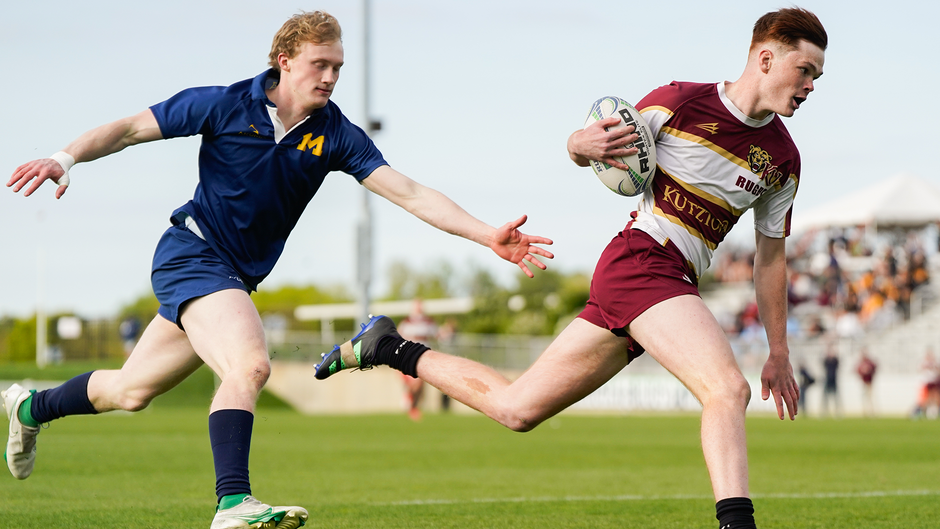 Henry Thomas of the Kutztown University men's rugby team outruns a University of Michigan defender for a try during the Collegiate Rugby Championship National 7s Premier Cup Quarterfinals on Friday, April 26, 2024.