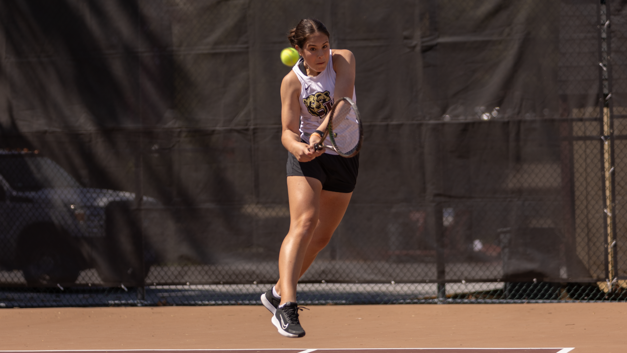Isabela de Nadai of the Kutztown University women's tennis team hits a backhand shot in a PSAC East match against West Chester on April 23, 2025.
