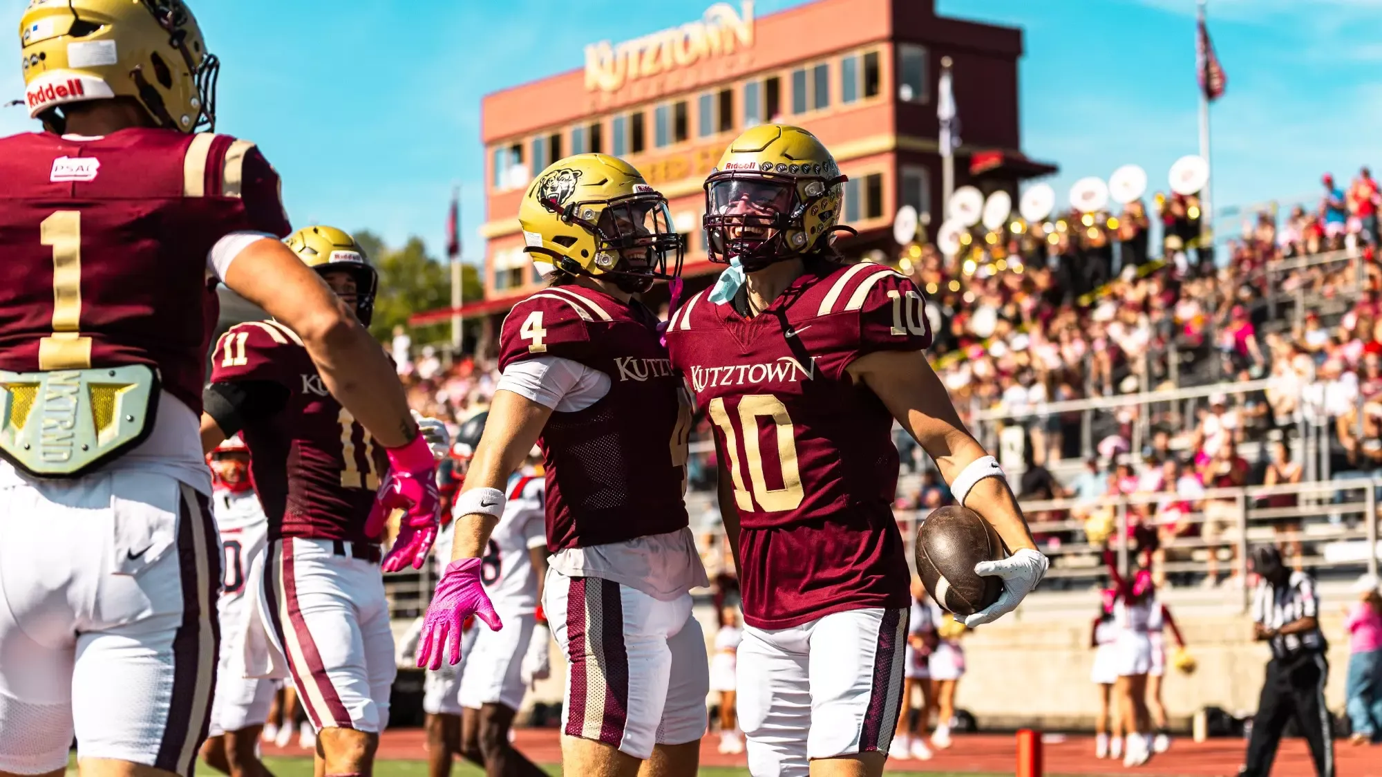 Rich Paczewski (4) and Trevor Amorim (10) celebrate following Amorim's first quarter touchdown during Kutztown's 49-0 win over Shippensburg on Saturday, Oct. 4, 2025.