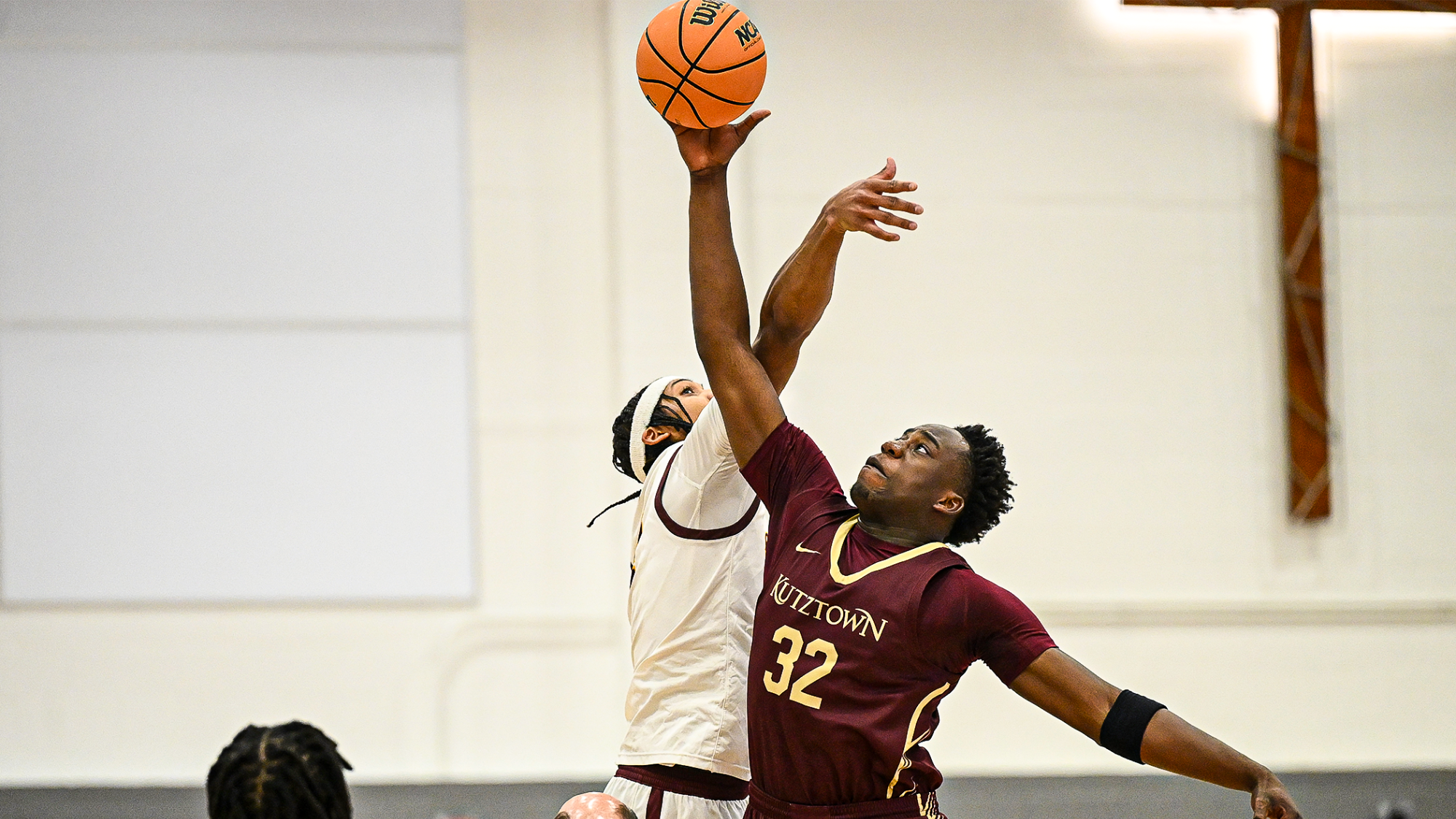 Tobi Ogunbare of the Kutztown University men's basketball team jumps for the opening tip in a PSAC crossover game at Gannon on Tuesday, Dec. 16, 2025.