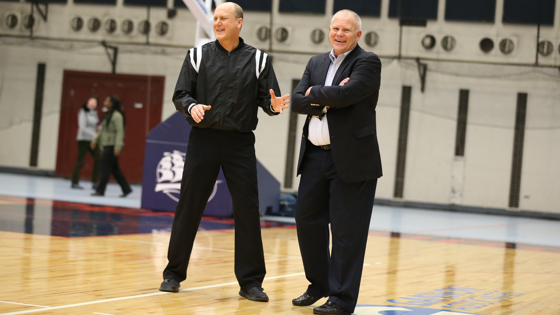 Kutztown head men's basketball coach Bernie Driscoll enjoys a lighthearted moment with an official prior to the Golden Bears' game at Shippensburg, Saturday, Jan. 12, 2019.