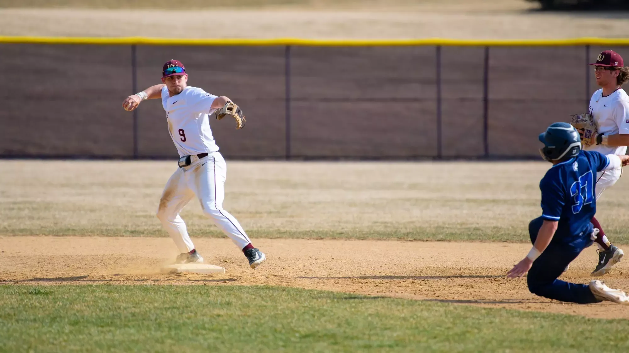 Nick Varda making a throw to first against Mercy 031425