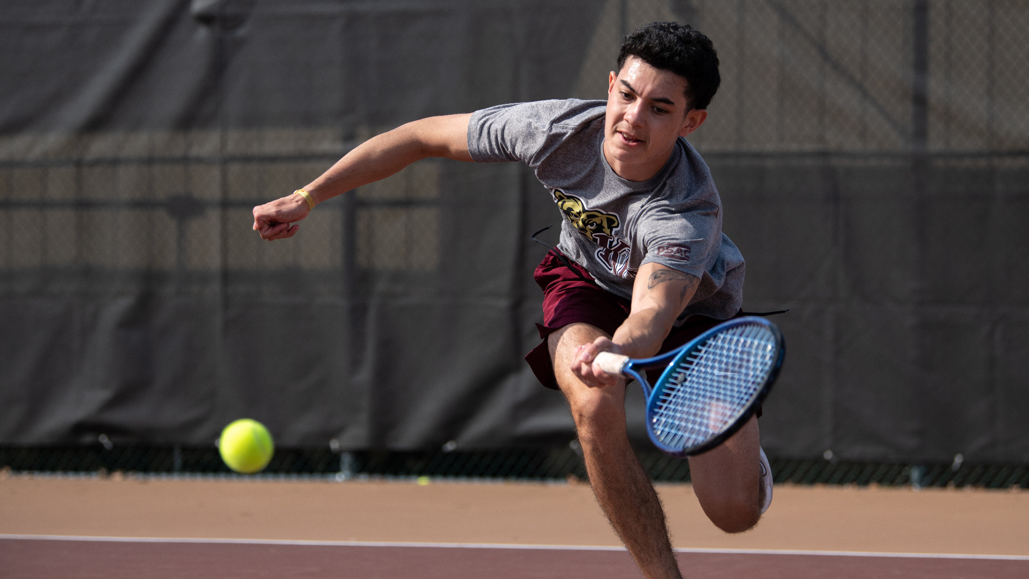 Raphael Hoareau Lebon of the Kutztown University men's tennis team returns a shot in a non-conference match against Fairmont State on Friday, March 14, 2025.