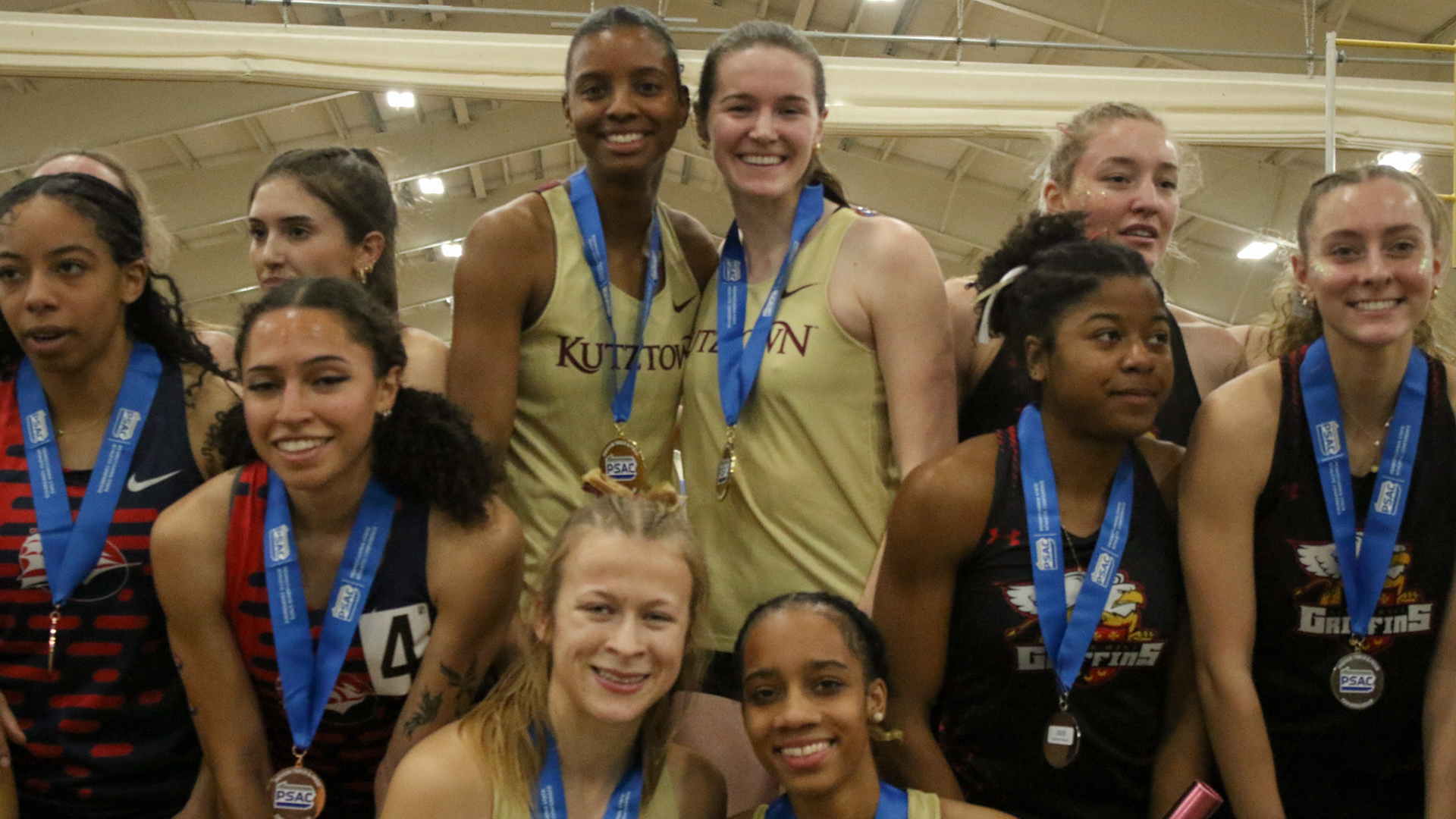 Kutztown 4x4 relay team with their gold medals at 2024-25 PSAC Indoor Championships, 3/2/25