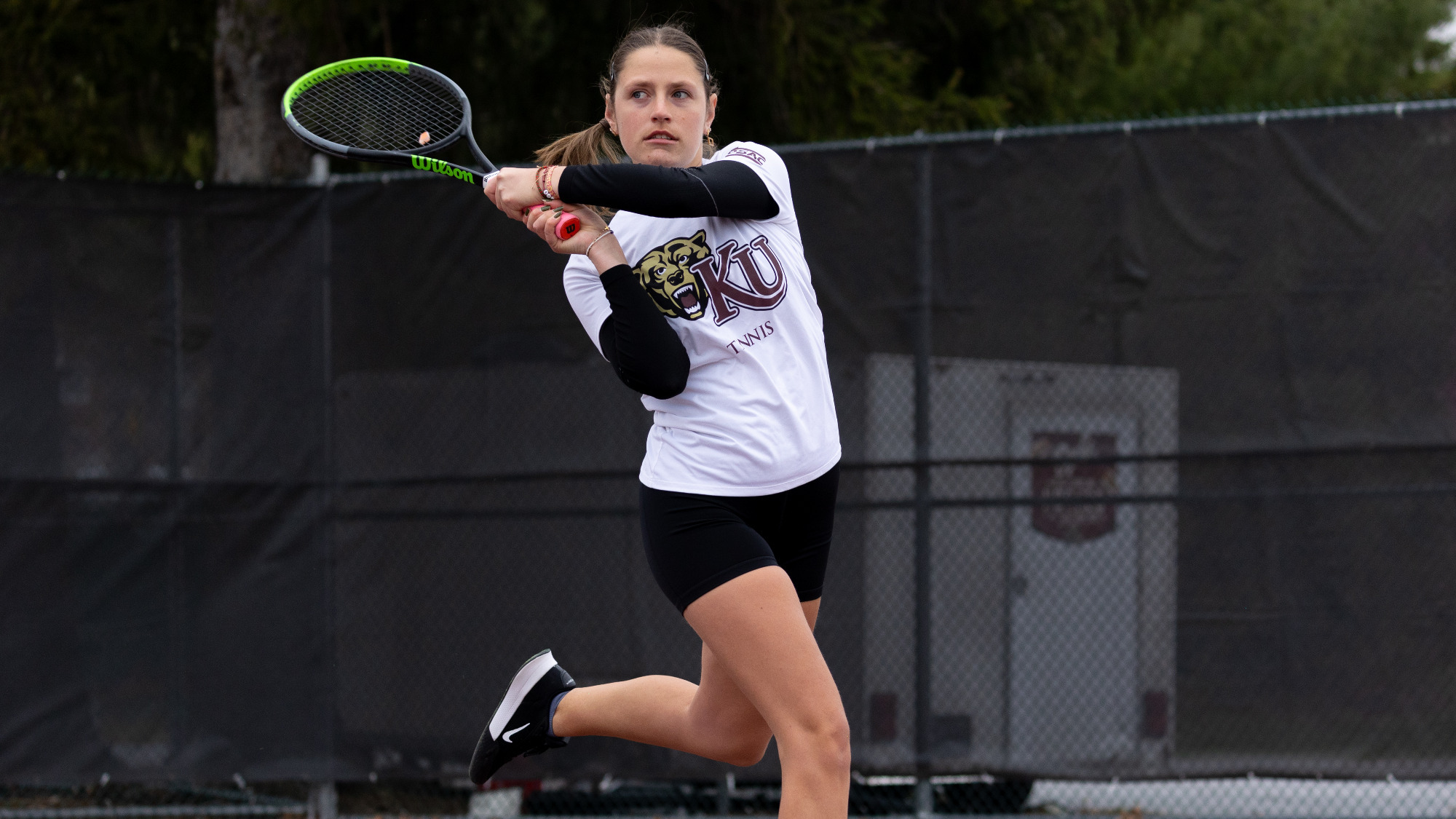 Emma Semery of the Kutztown University women's tennis team follows through on a backhand shot during a PSAC East match against Shippensburg on April 2, 2025.