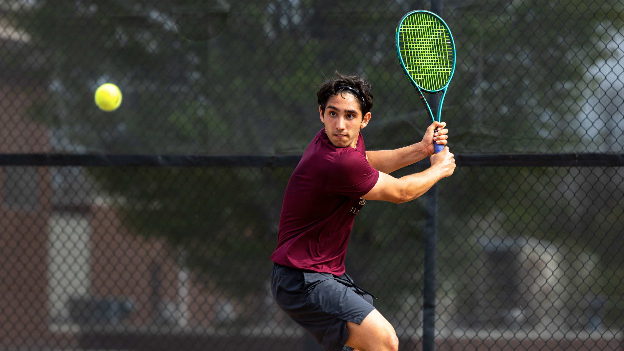 Henrique Rocha of the Kutztown University men's tennis team prepares to hit a backhand shot in a match against West Chester on Tuesday, April 22, 2025. The Golden Bears won the match 5-2 to clinch their first PSAC Championship tournament berth since 2018.