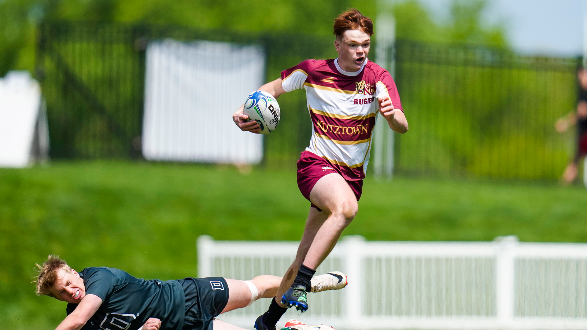 Henry Thomas of the Kutztown University men's rugby team evades a Dartmouth player during the Collegiate Rugby Championship National 7s on April 26, 2024.