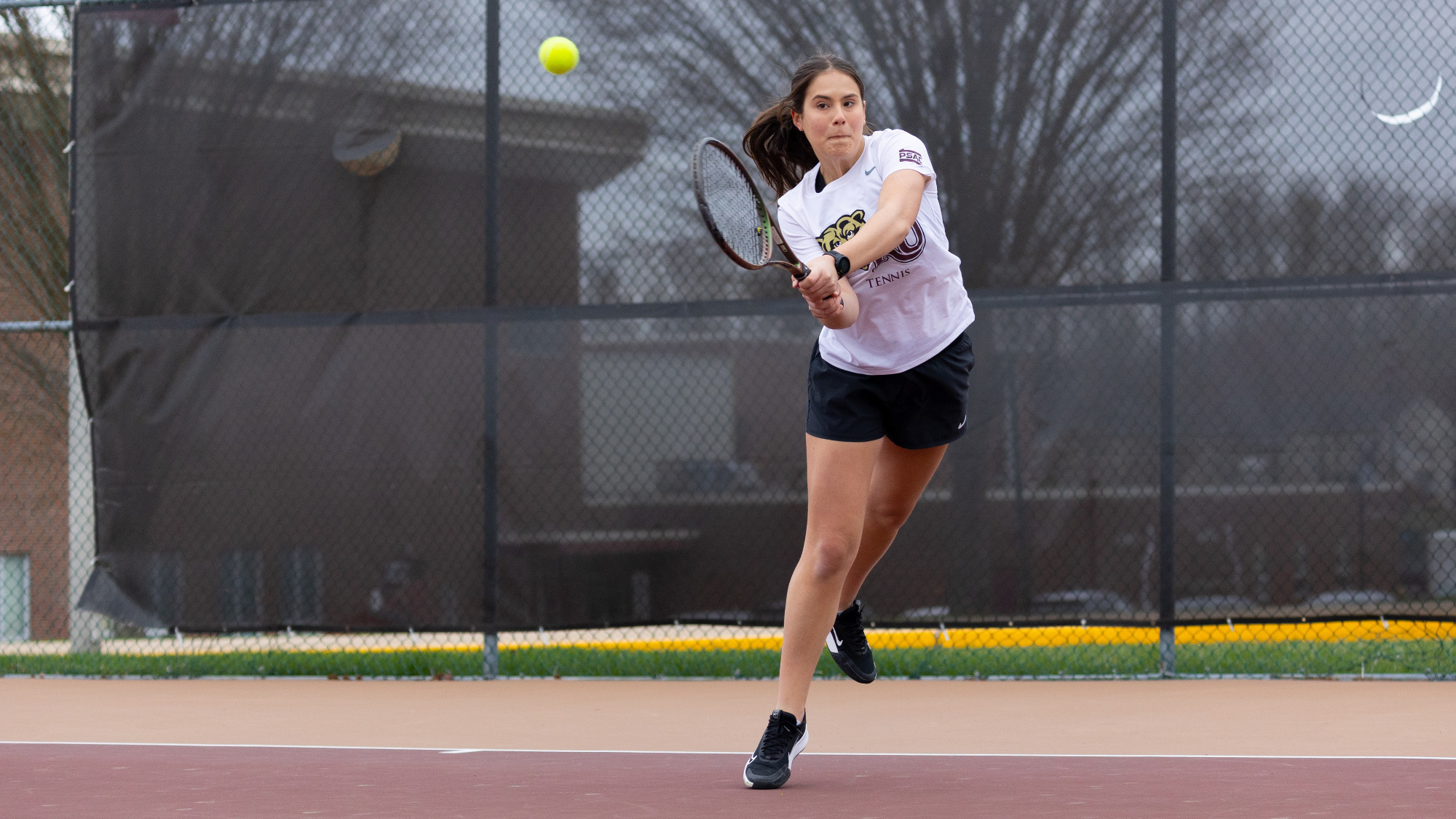 Isabela de Nadai of the Kutztown women's tennis team hits a backhand shot against Shippensburg on April 2, 2025.