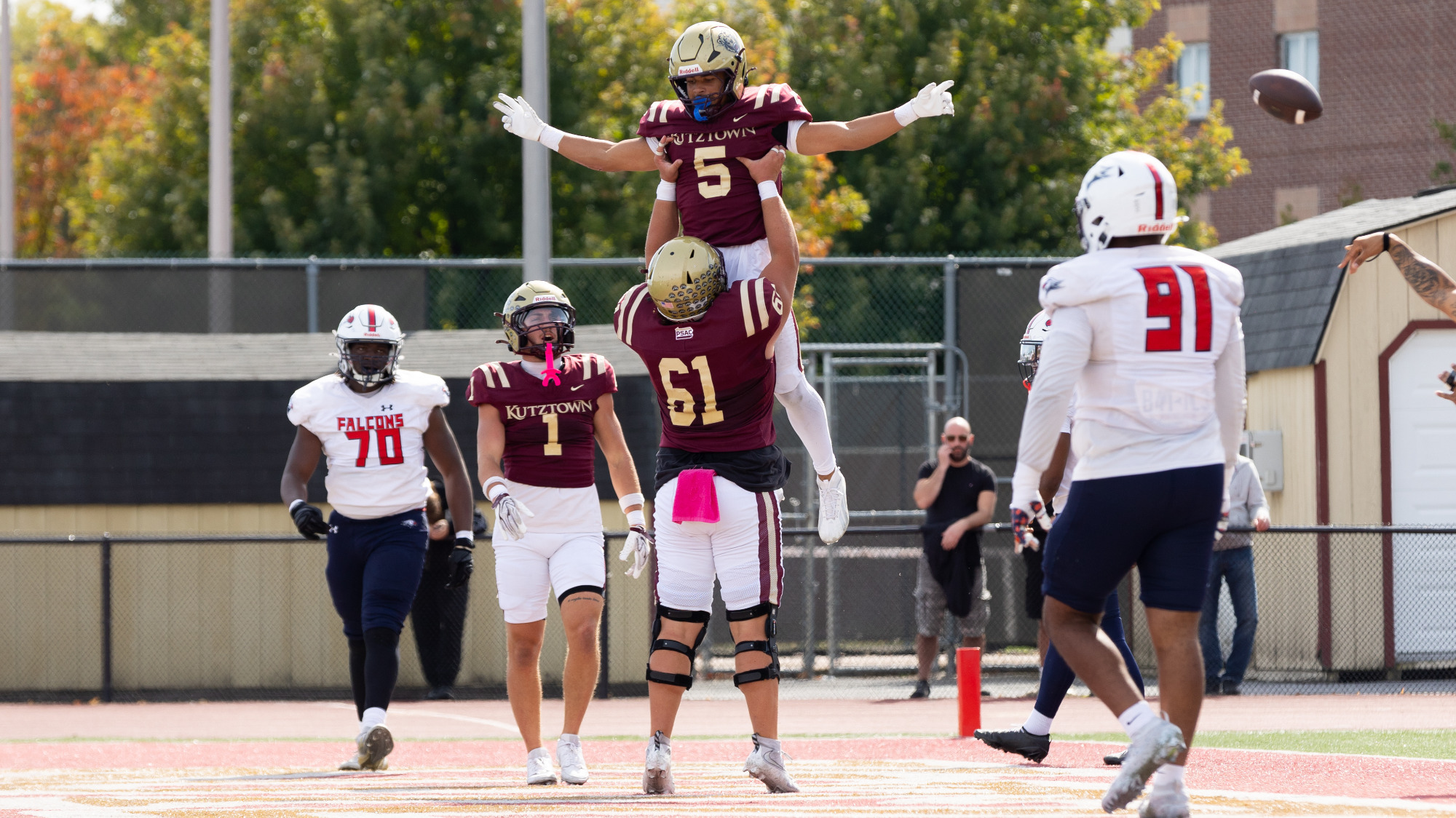 Kutztown University football running back Jaedyn Stewart (5) celebrates with teammate CJ Conti (61) after scoring one of his three rushing touchdowns in the third-ranked Golden Bears 56-0 win over Lackawanna on Saturday, Oct. 10, 2026.