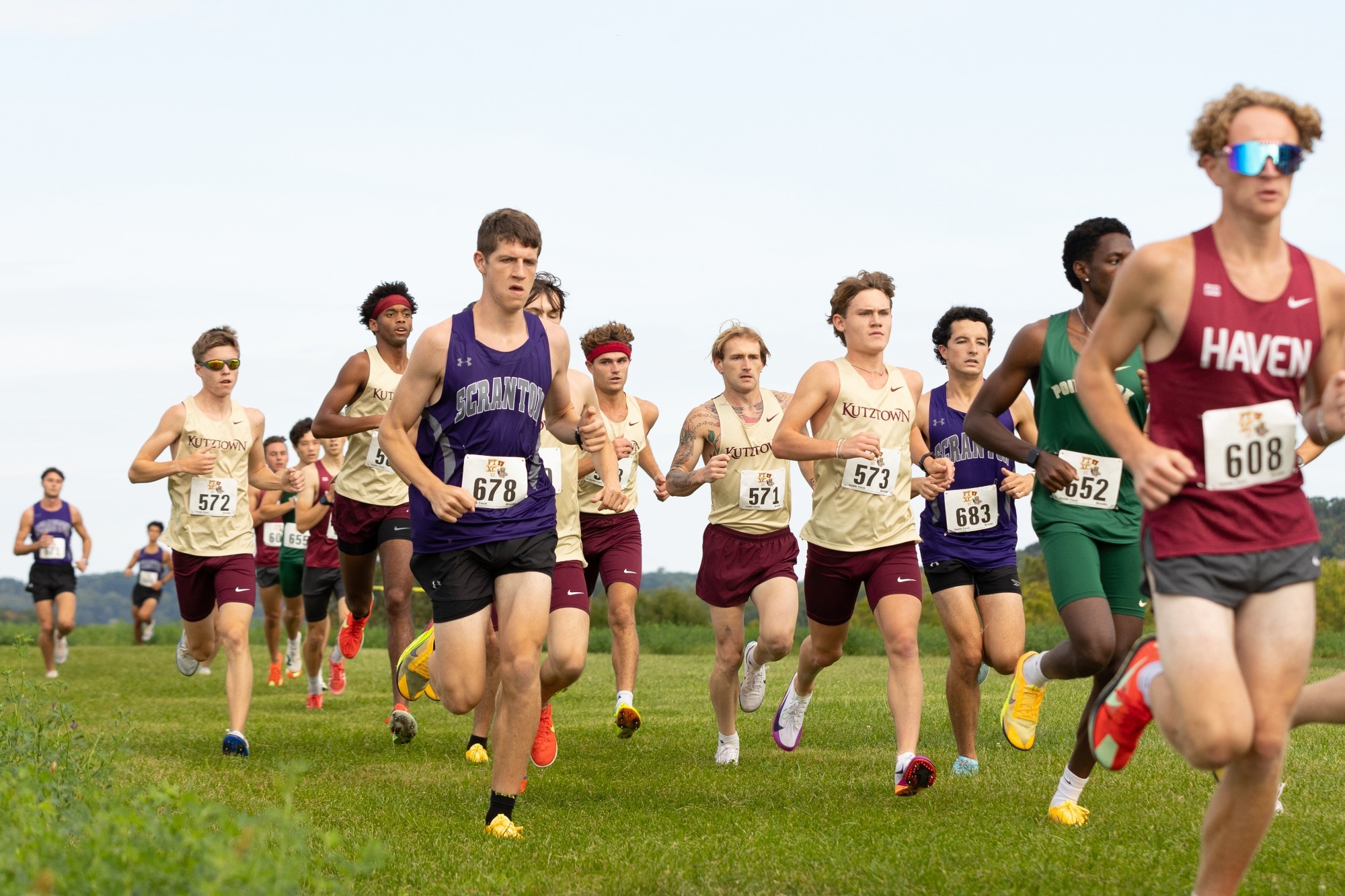 Kutztown men's cross country running as a group at the Division II/III Challenge, 9/12/26