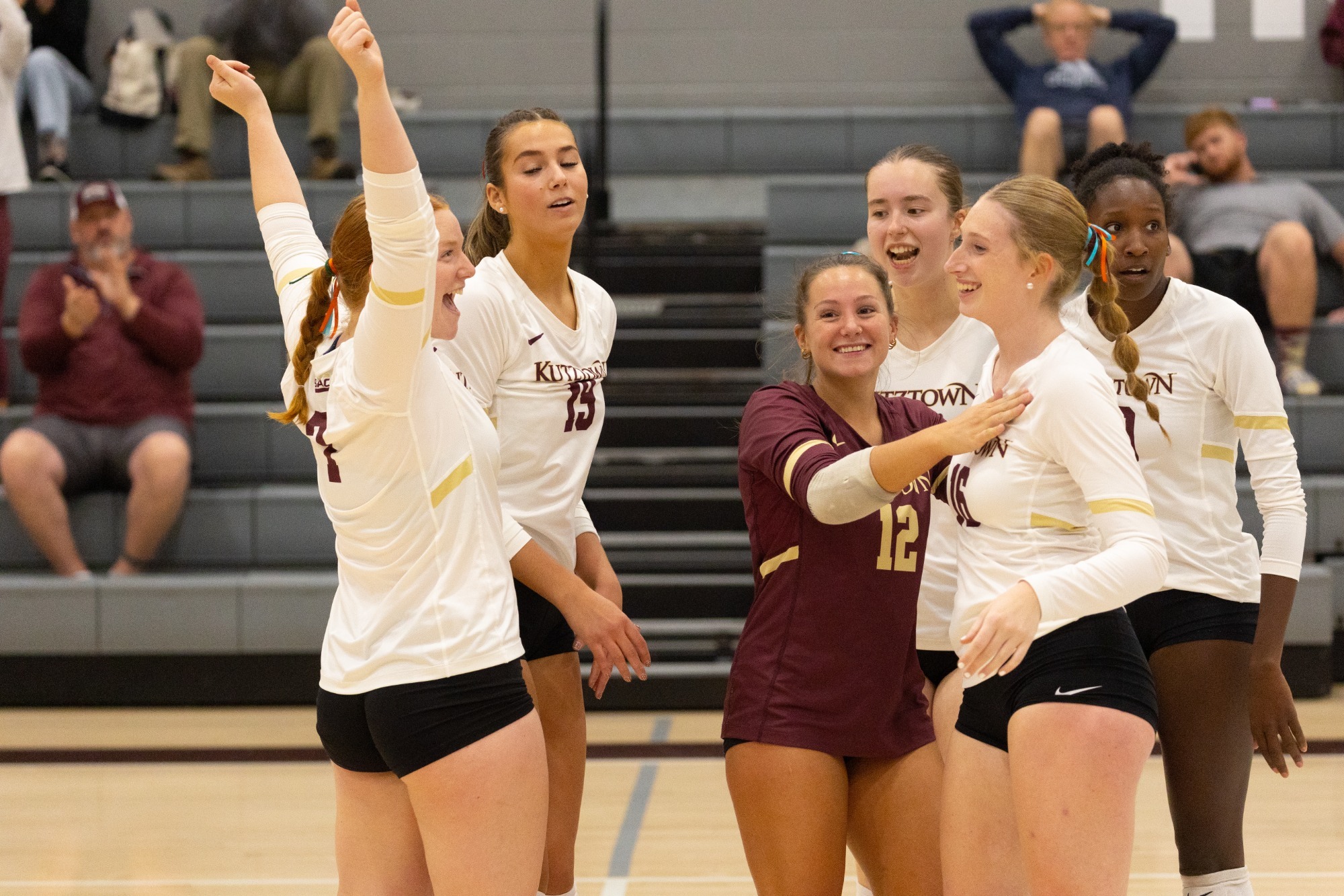 Kutztown women's volleyball celebrating on the court vs. Lackawanna, 9/22/26