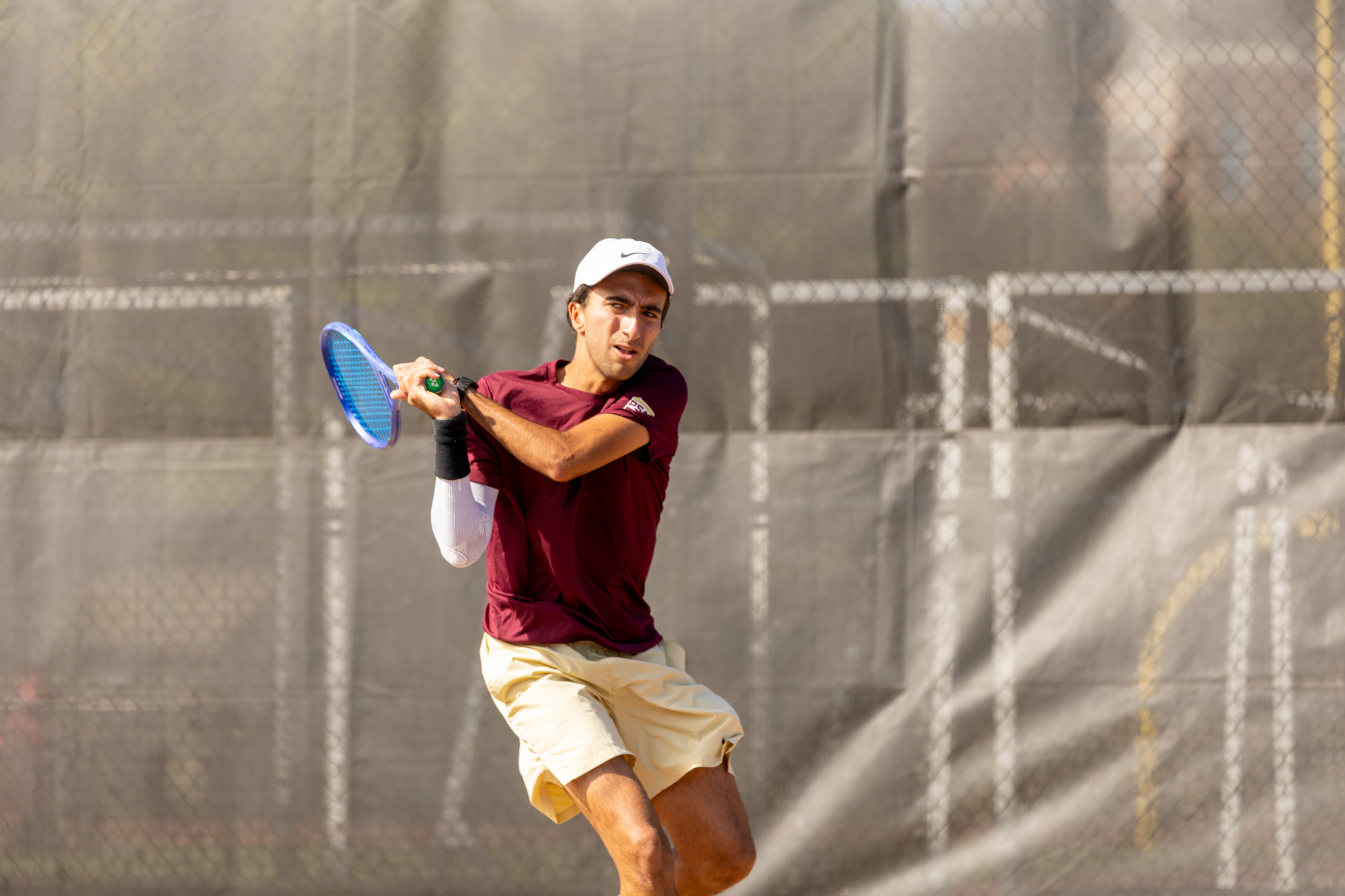 Nacho Costa swinging a back hand vs. Davis & Elkins, 10/3/26