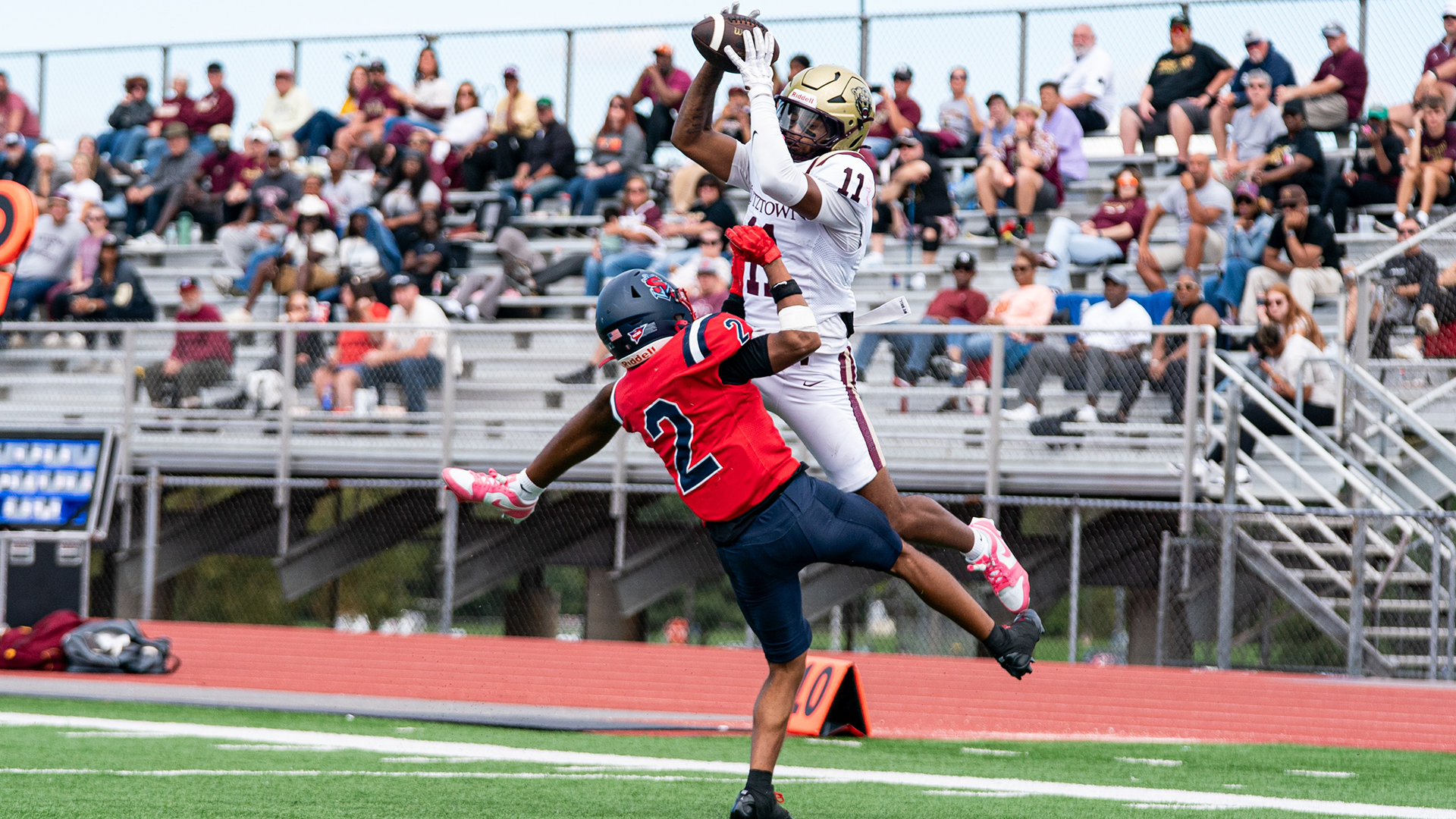 Wide receiver Ty'renne Hynson of the Kutztown University football team leaps over a Shippensburg defensive back for a 24-yard touchdown reception in the Golden Bears' 59-7 PSAC East victory at Seth Grove Stadium on Saturday, Oct. 3, 2026.