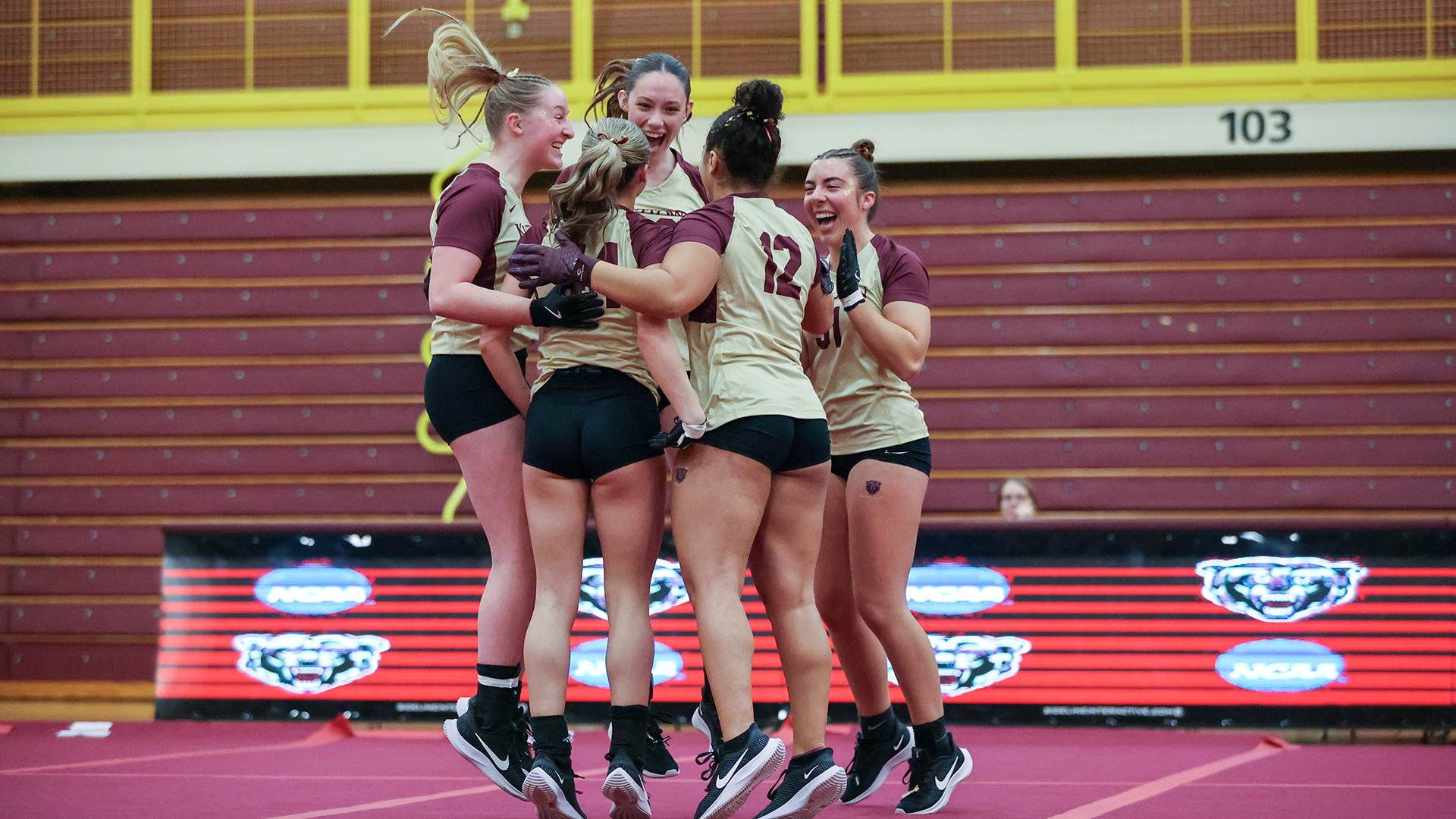 Members of the Kutztown University acrobatics & tumbling team's acro 5-element heat celebrate after scoring an 8.95 during a tri-meet against Frostburg State and West Liberty on Friday, Feb. 27, 2026.