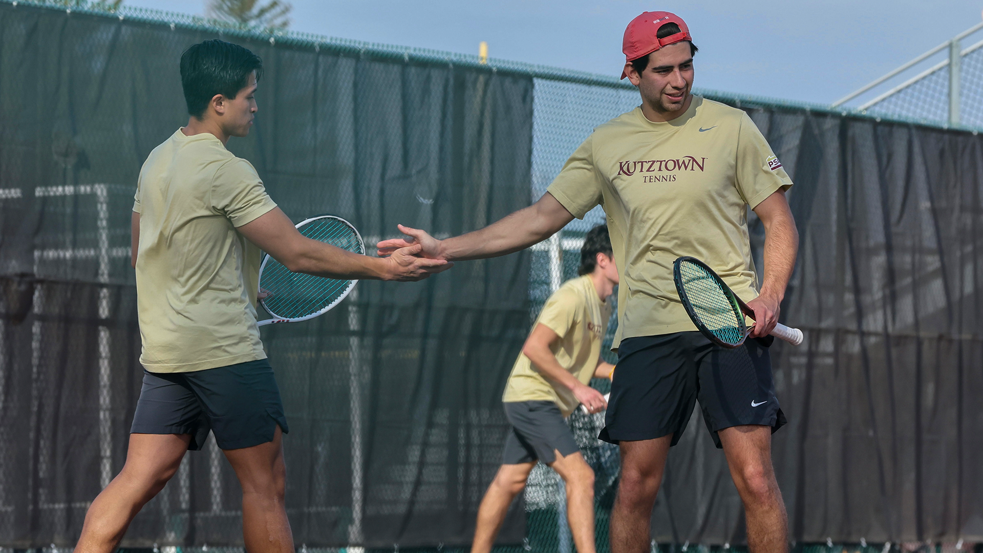 Dang Nguyen and Henrique Rocha of the Kutztown University men's tennis team celebrate after winning a point at No. 1 doubles in a non-conference match on Wednesday, March 11, 2026.
