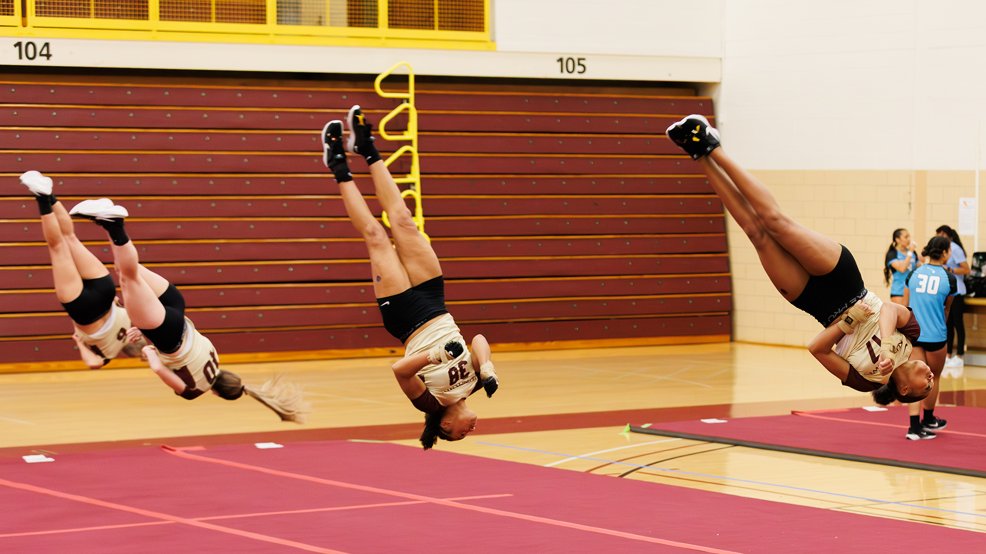 Troi Minor (17) and Natalie Watson (38) of the Kutztown University acrobatics & tumbling team perform a flip routine during a meet against Hawaii Pacific on Tuesday, March 10, 2026.