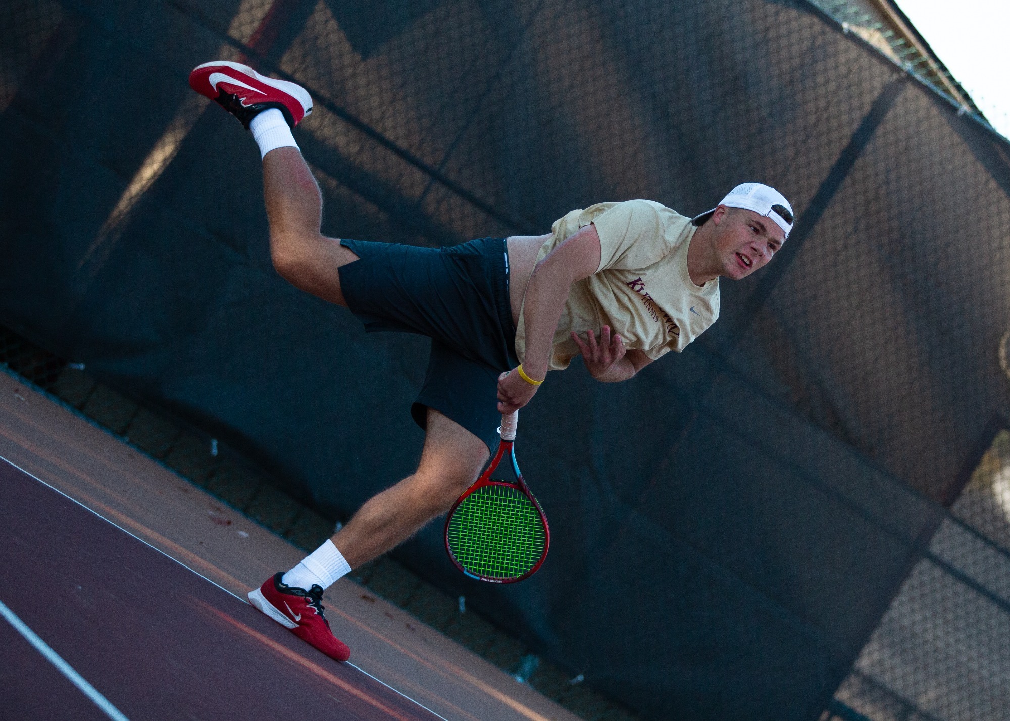 Patrick Young of the Kutztown University men's tennis team follows through on a serve in a match against Moravian on Oct. 16, 2025.