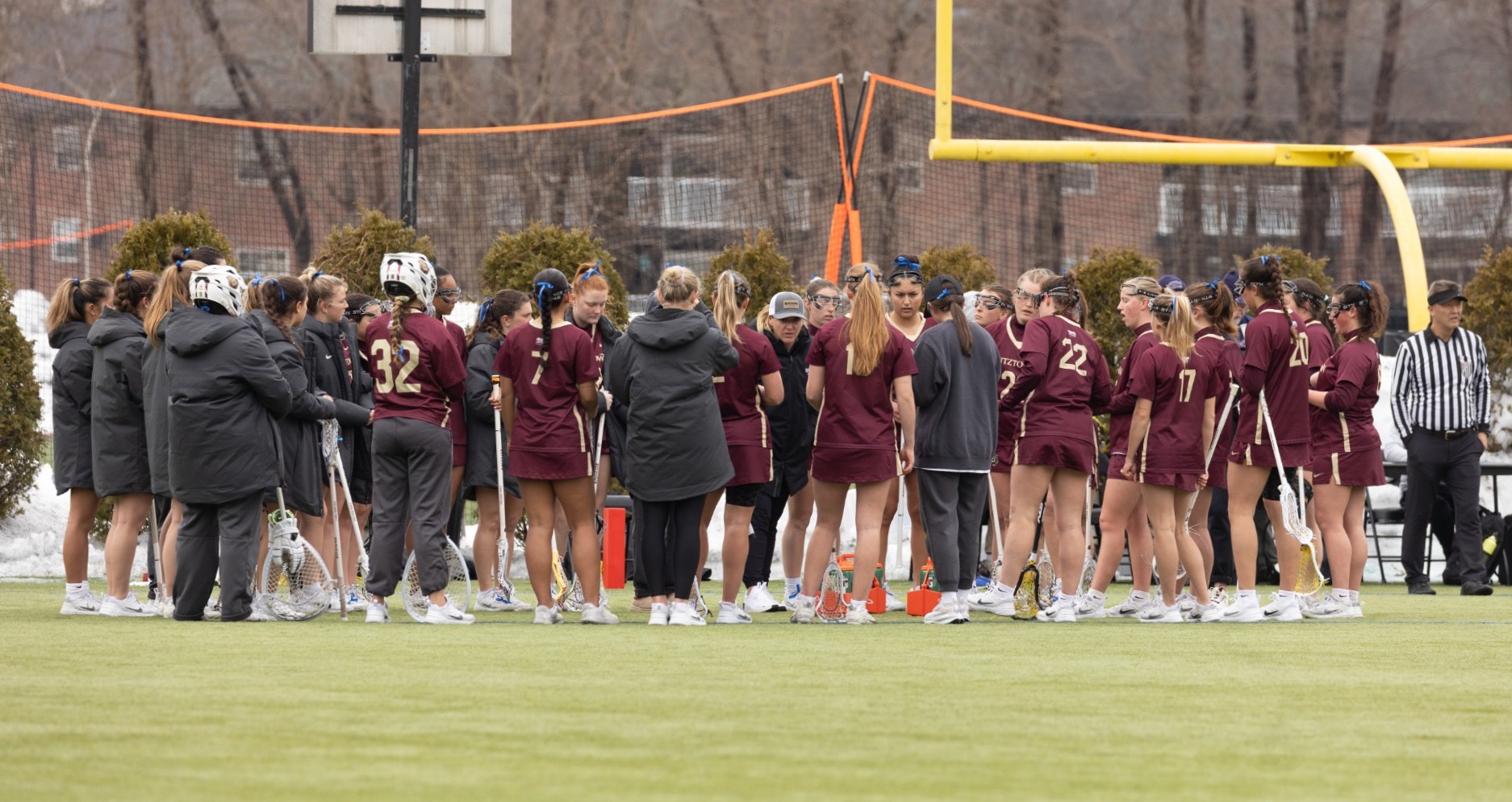Coach Nicholson talks to team in huddle @ Bentley during spring break trip 2026