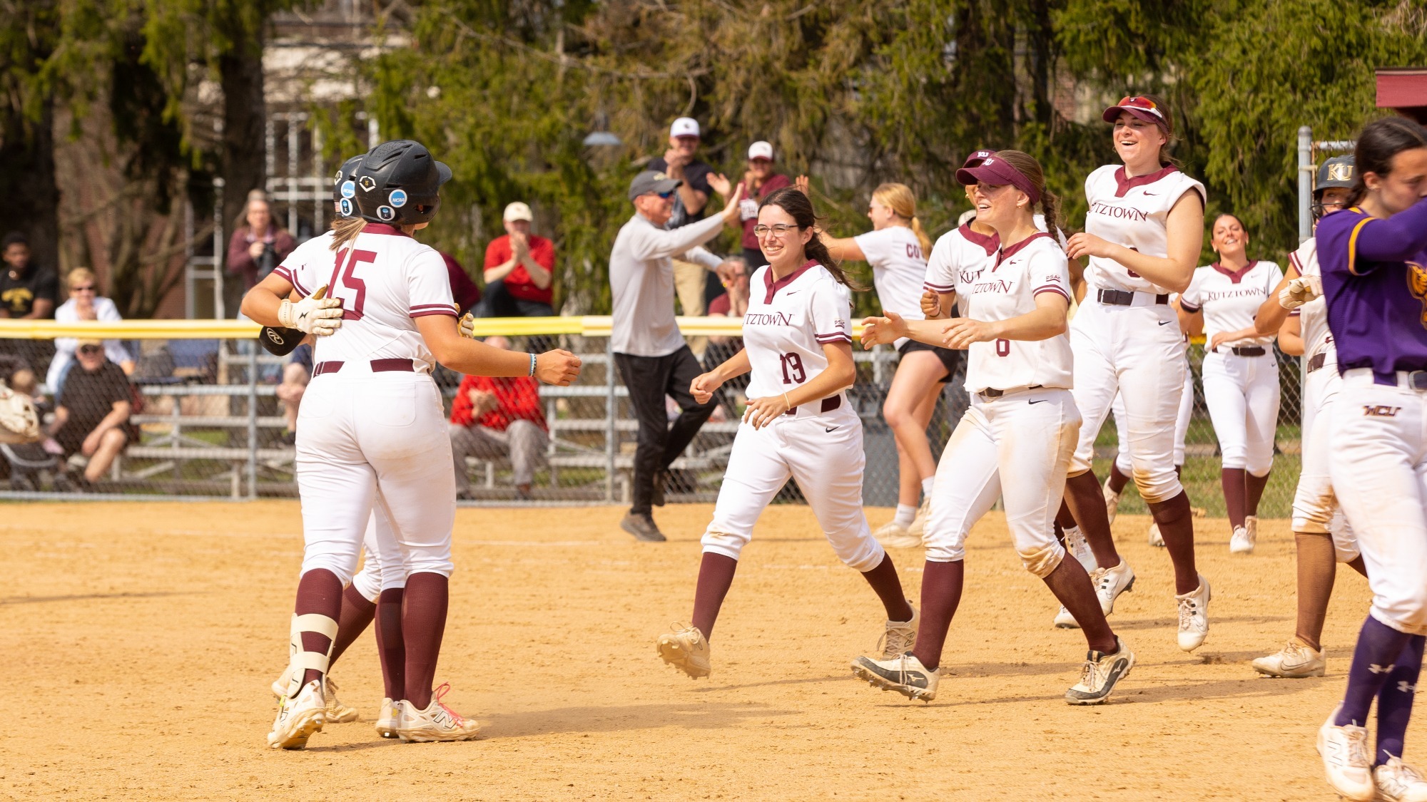 The Kutztown University softball team celebrates after a 4-3 game one victory over West Chester on March 31, 2026.