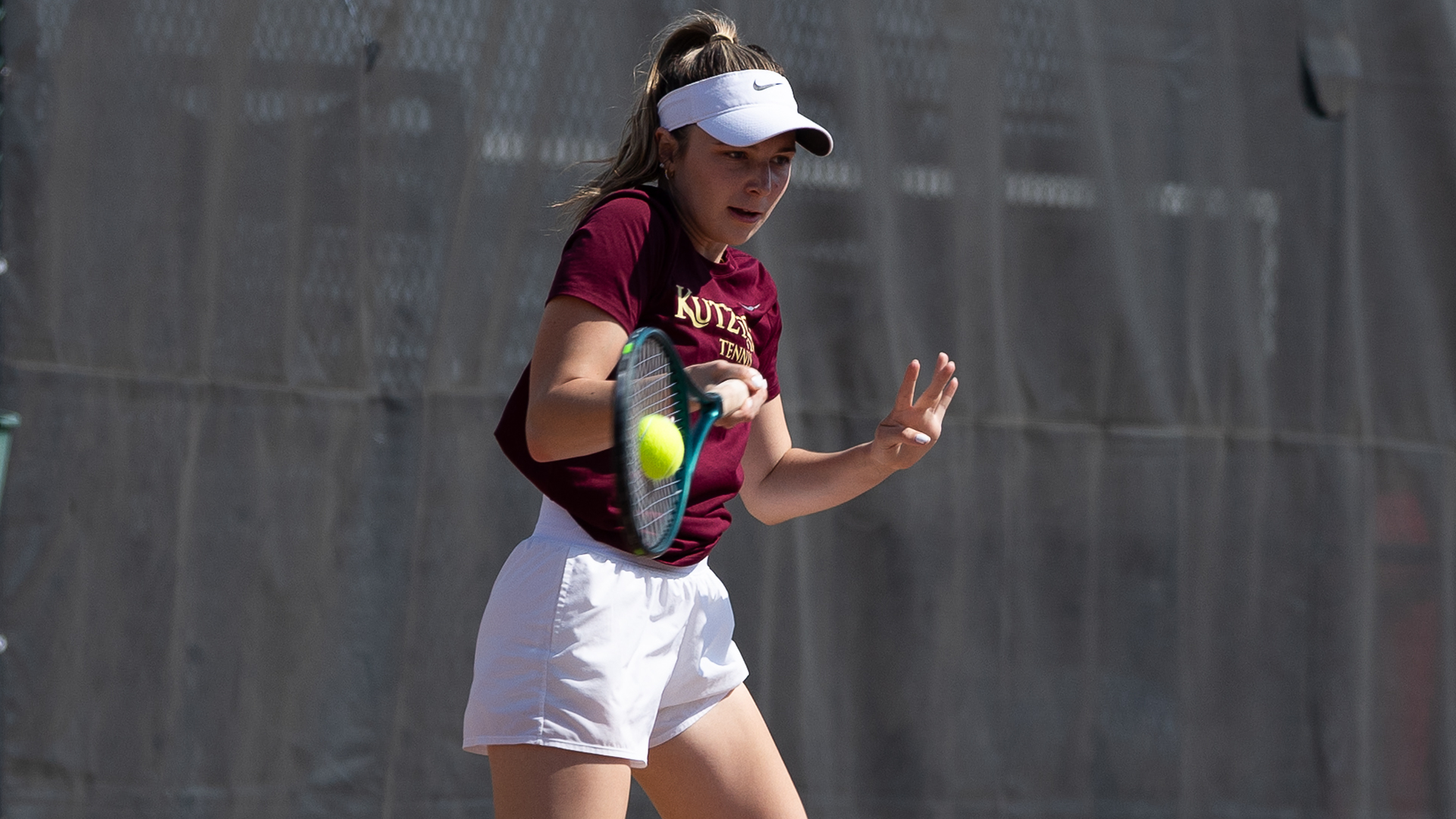 Gabby Gentile of the Kutztown University women's tennis team hits a forehand shot during a match against Goldey-Beacom on Saturday, April 4, 2026.