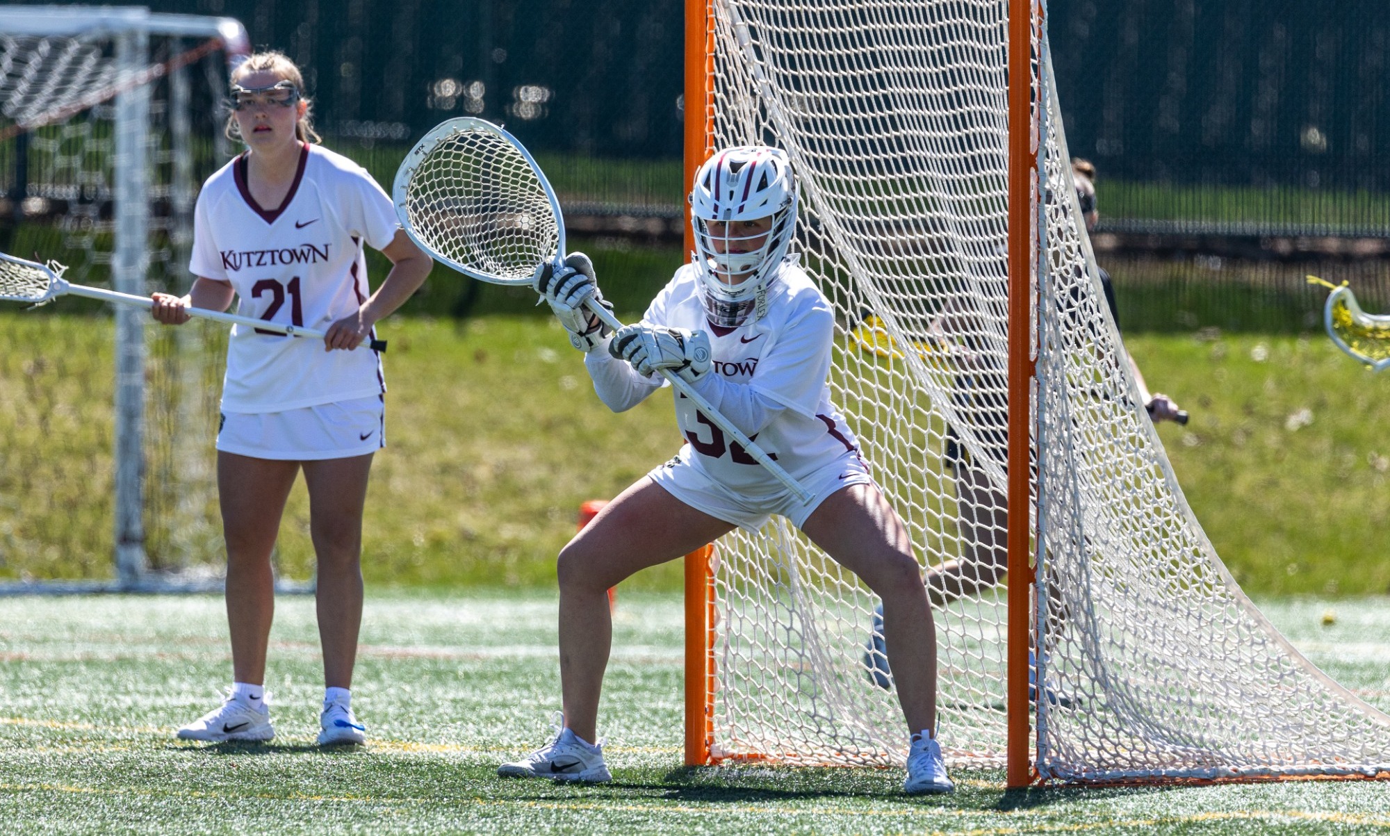 Marisa Bragg stands in cage next to teammate Brynn Axe 2026