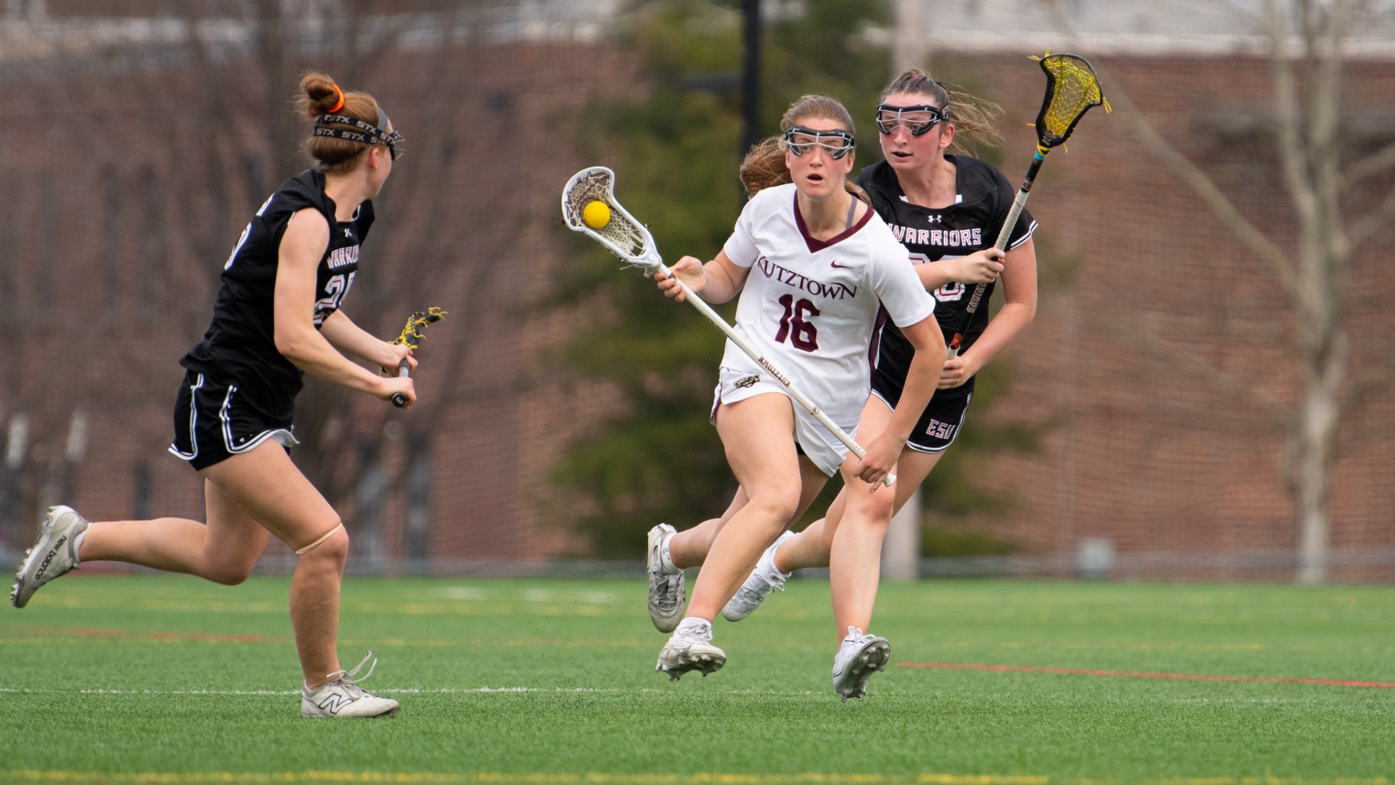Defender Rowan Hall of the Kutztown University women's lacrosse team looks to evade East Stroudsburg defenders in a game at Keystone Field on March 11, 2026.