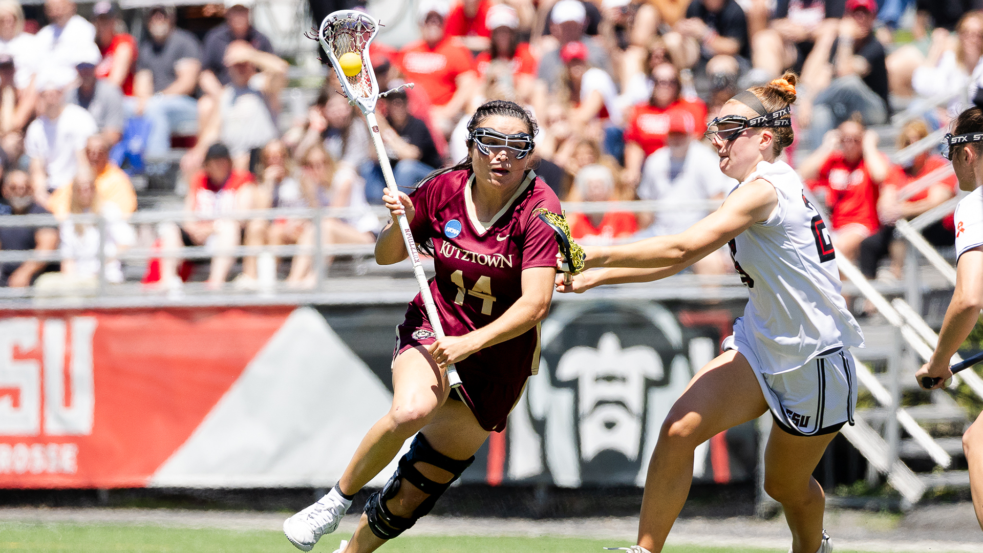 Katie Yocum of the Kutztown University women's lacrosse team drives against an East Stroudsburg defender during the Golden Bears' NCAA Division II quarterfinal game on Saturday, May 16, 2026.