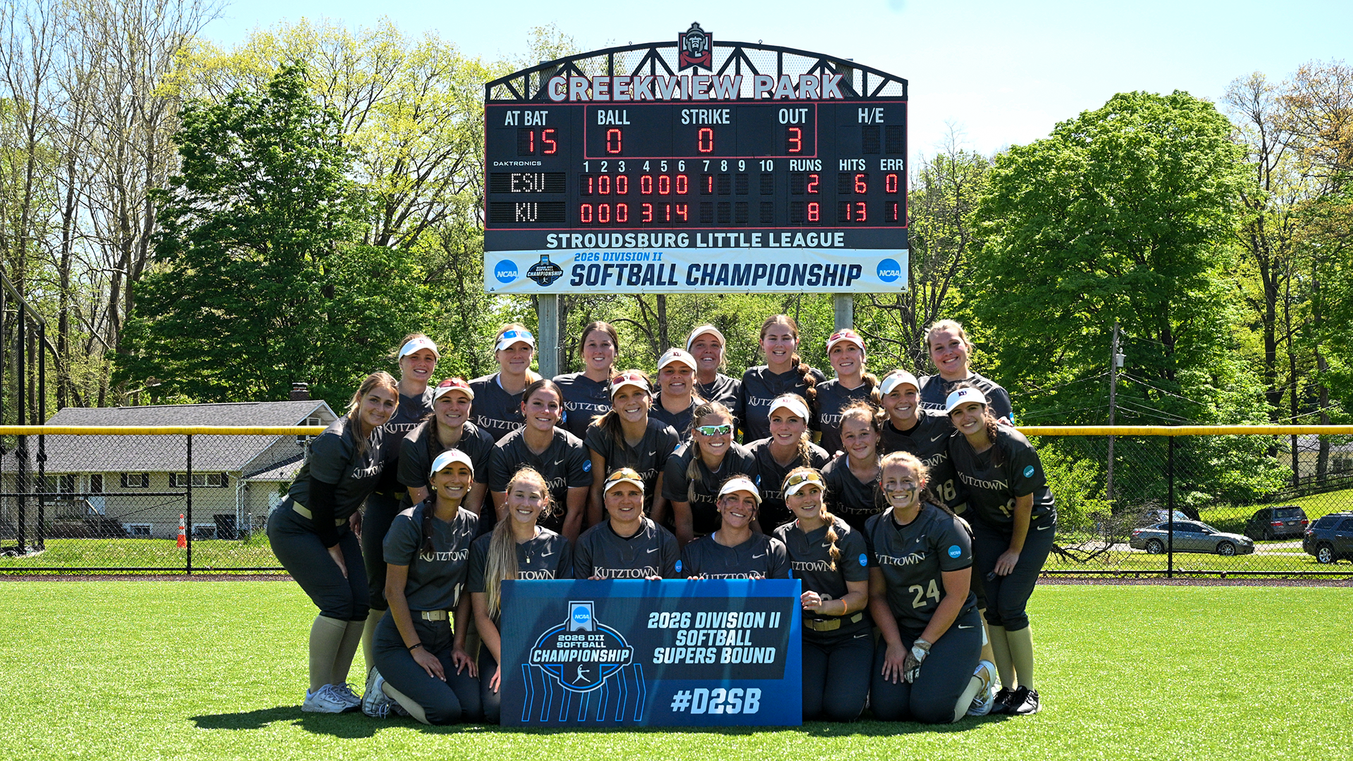 The Kutztown University softball team poses with a Super Regionals bound sign after defeating East Stroudsburg 8-2 to advance to the Atlantic Super Regional on Saturday, May 16, 2026.