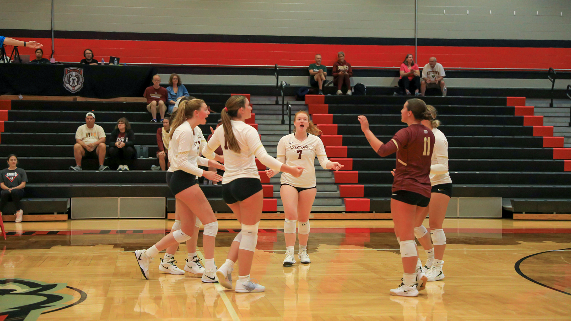 Members of the Kutztown University women's volleyball team, including Emma Baldridge (7) and Saige Thibodeaux (11), celebrate after scoring a point against Lock Haven on Friday, Aug. 28, 2026.