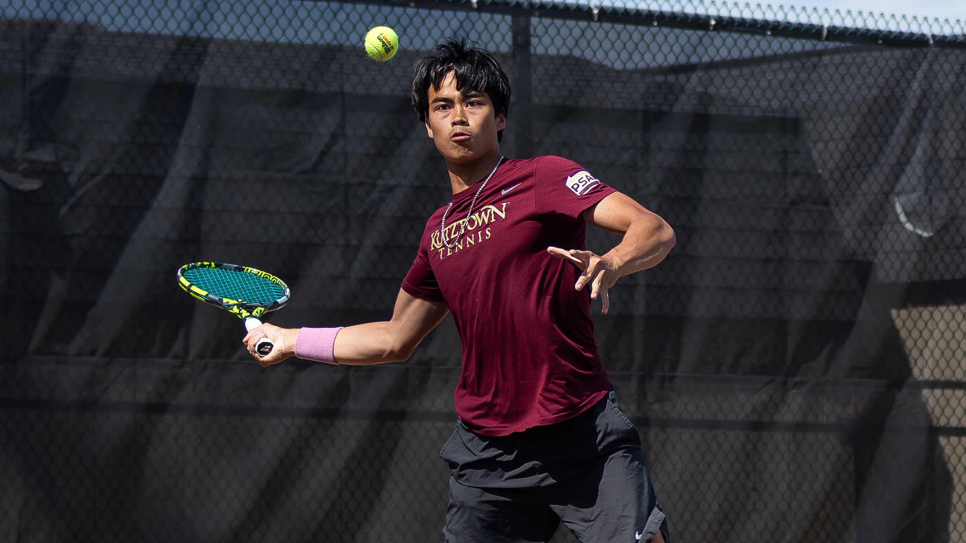 Dang Nguyen of the Kutztown University men's tennis team hits a forehand shot during a match against Chestnut Hill on April 23, 2026.