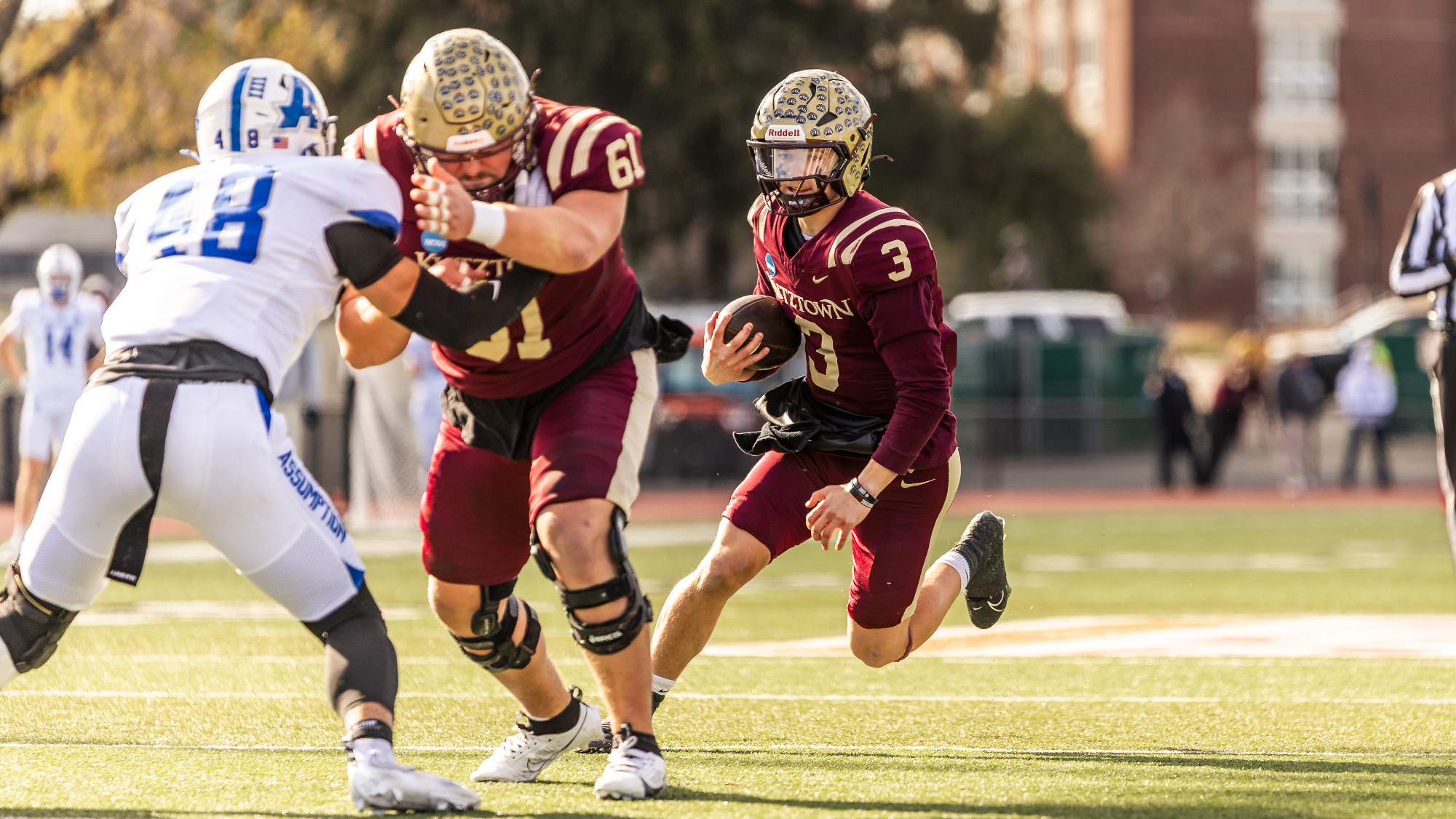 Judd Novak (3) of the Kutztown University football team looks to run behind the block of CJ Conti (61) during the Golden Bears' NCAA DII Second Round victory over Assumption, Saturday, Nov. 29, 2025.