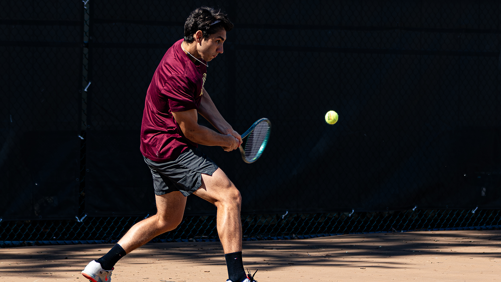 Henrique Rocha of the Kutztown University men's tennis team hits a backhand shot during a match against Chestnut Hill on April 23, 2026.