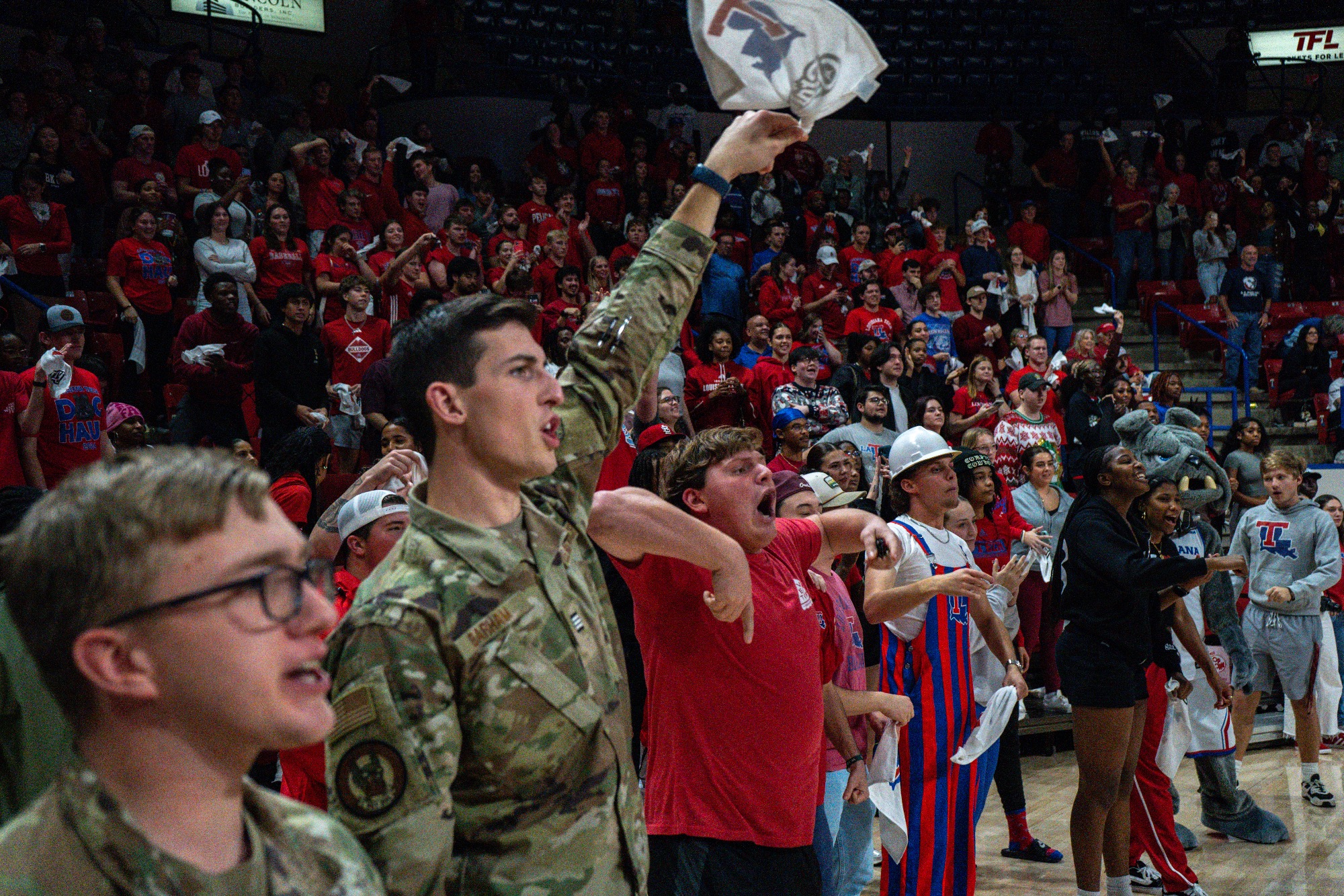 LA Tech basketball student section with a student waving a flag