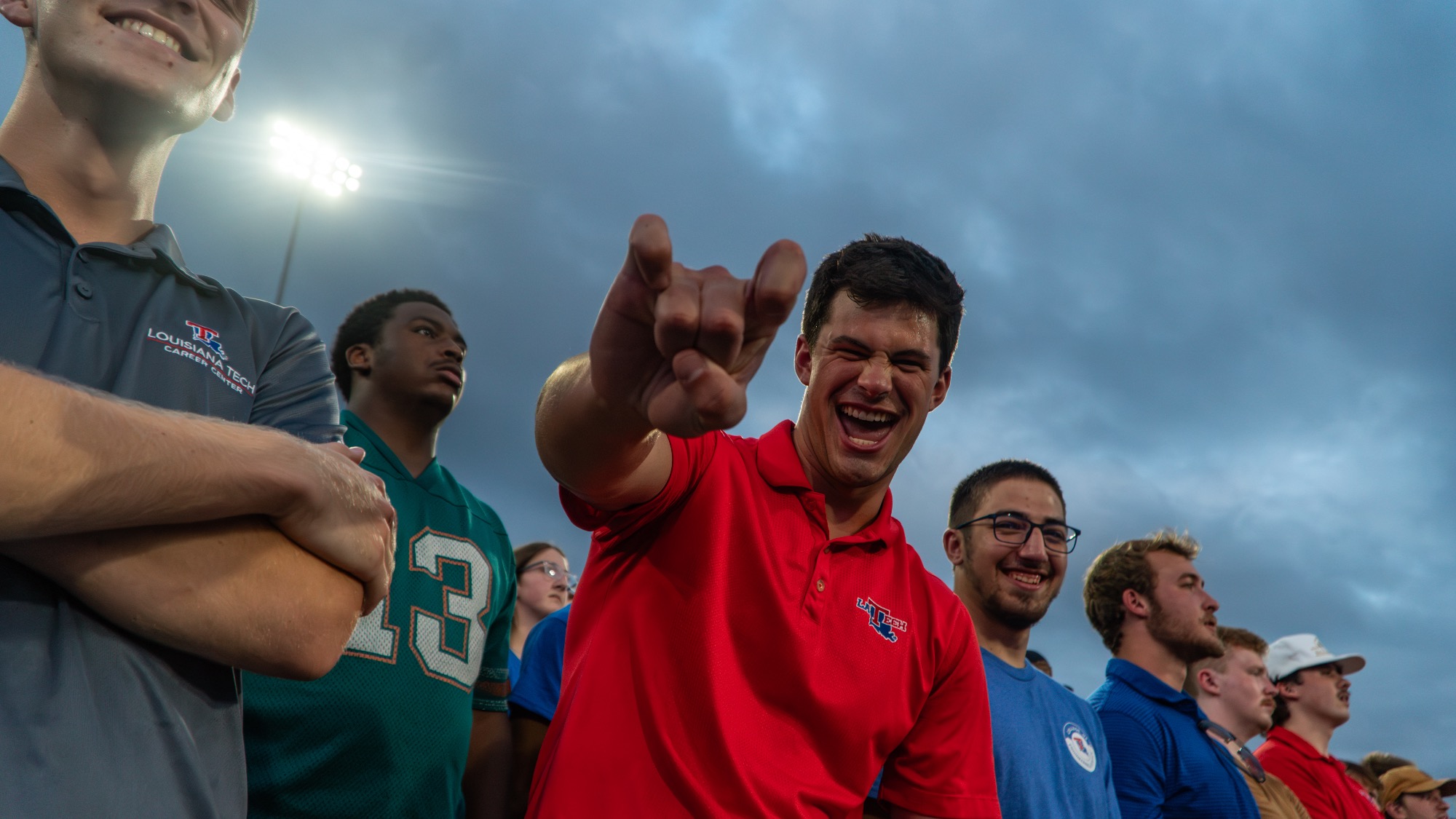 LA Tech student pointing and cheering in the student section