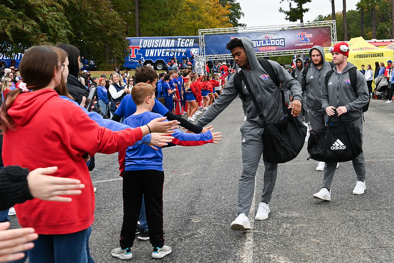 Louisiana Tech football player greeting a young fan during the Bulldog Walk of Pride