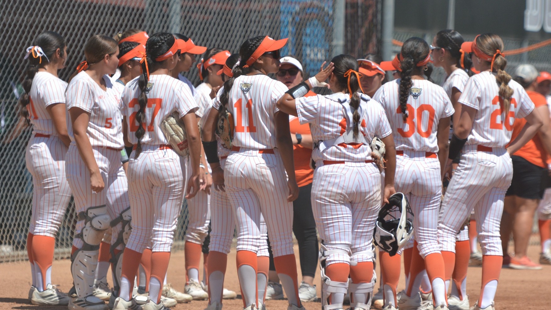 The La Verne softball team gathers during the second round of the SCIAC Tournament..