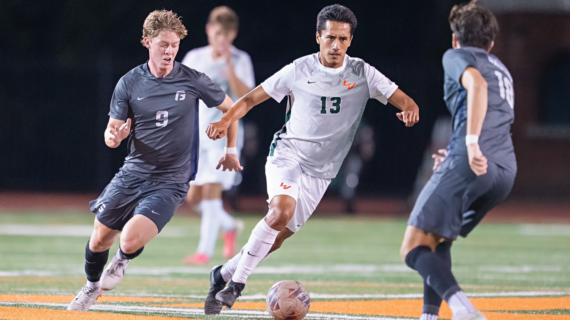 Tyler Valdez drives through George Fox defenders