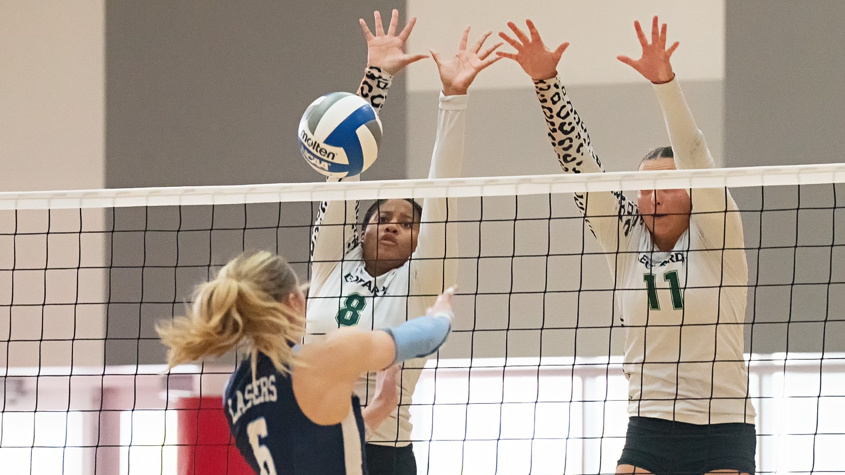 Zacky Coaston blocks an attack against Lasell