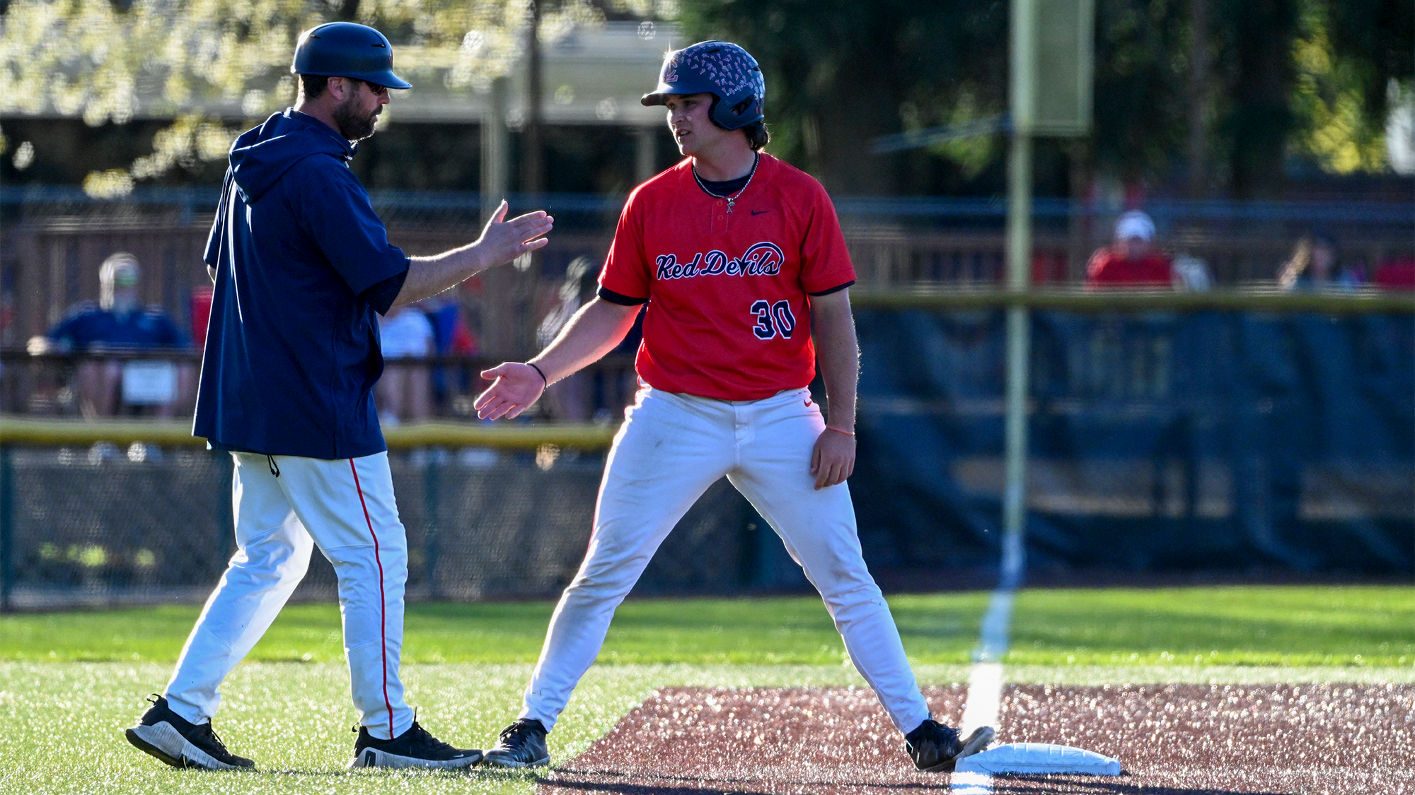 Harlan Rowe high fives with Coach Lupinski