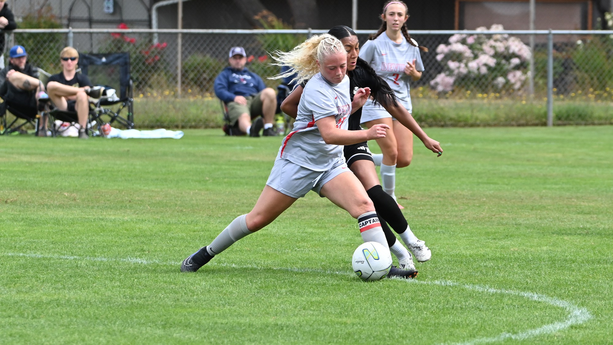 Maylee Reynolds battles for control of the ball vs Highline
