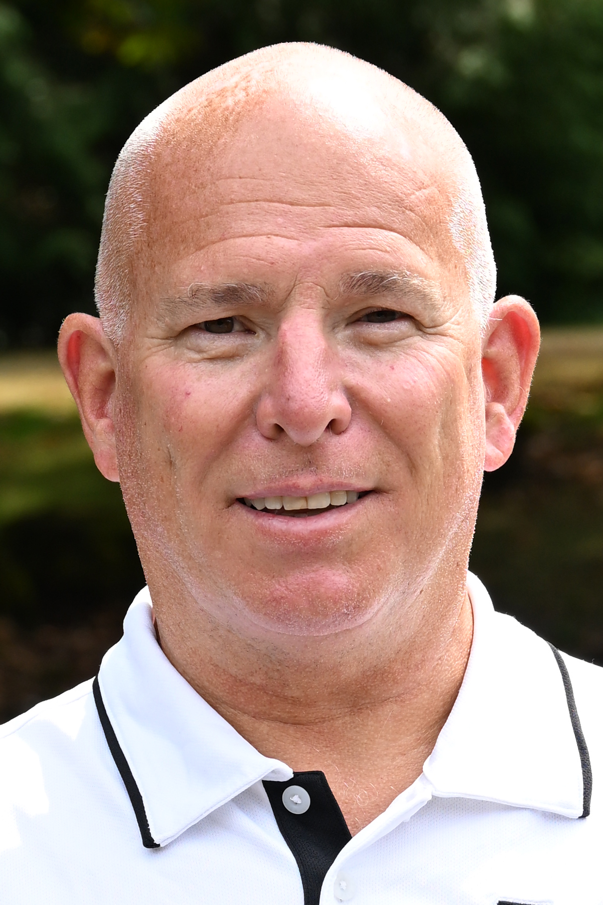 Jud Keim poses in front of a green background