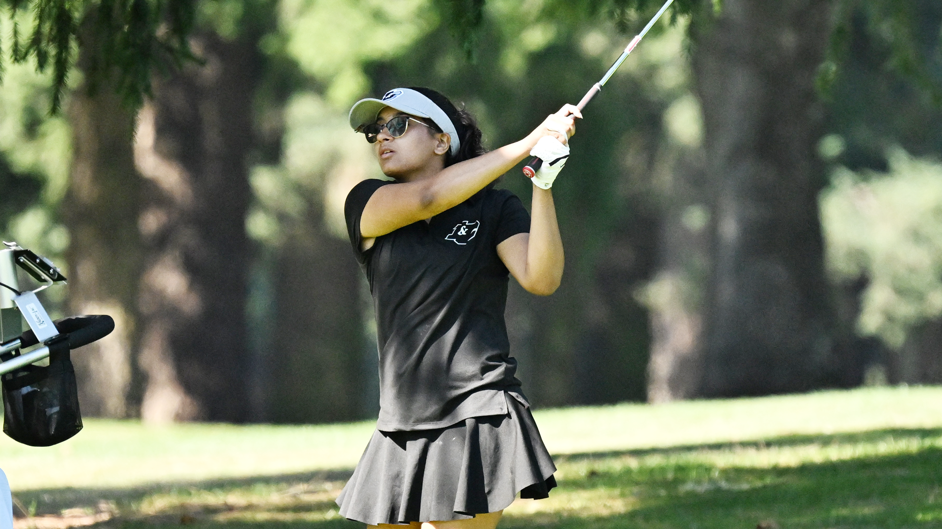 Ahika Jani watches an iron shot fly towards the hole 