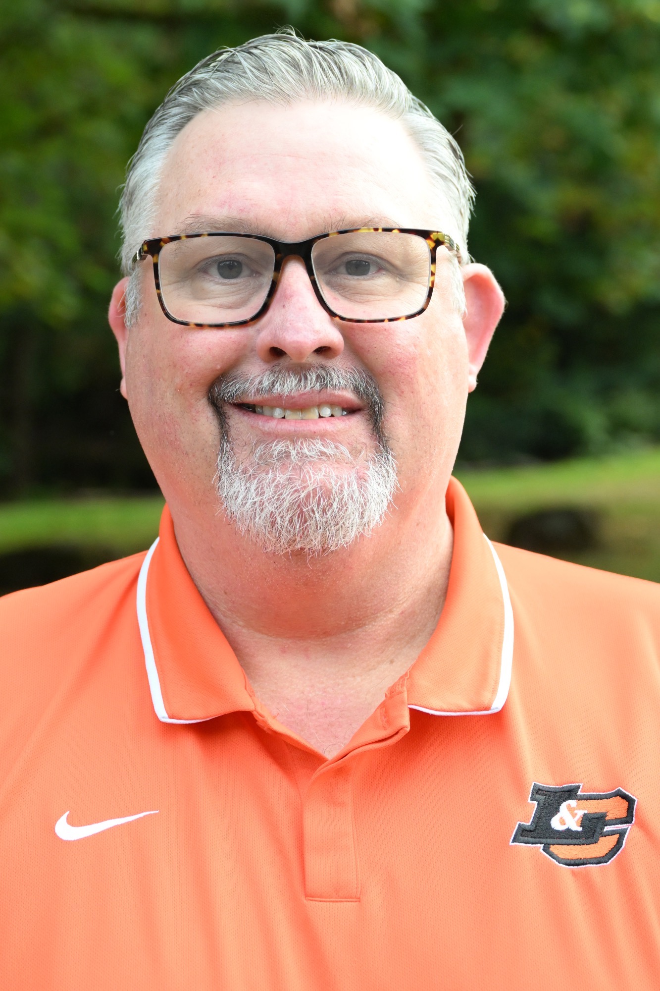 Shanan Rosenberg poses in front of a green background