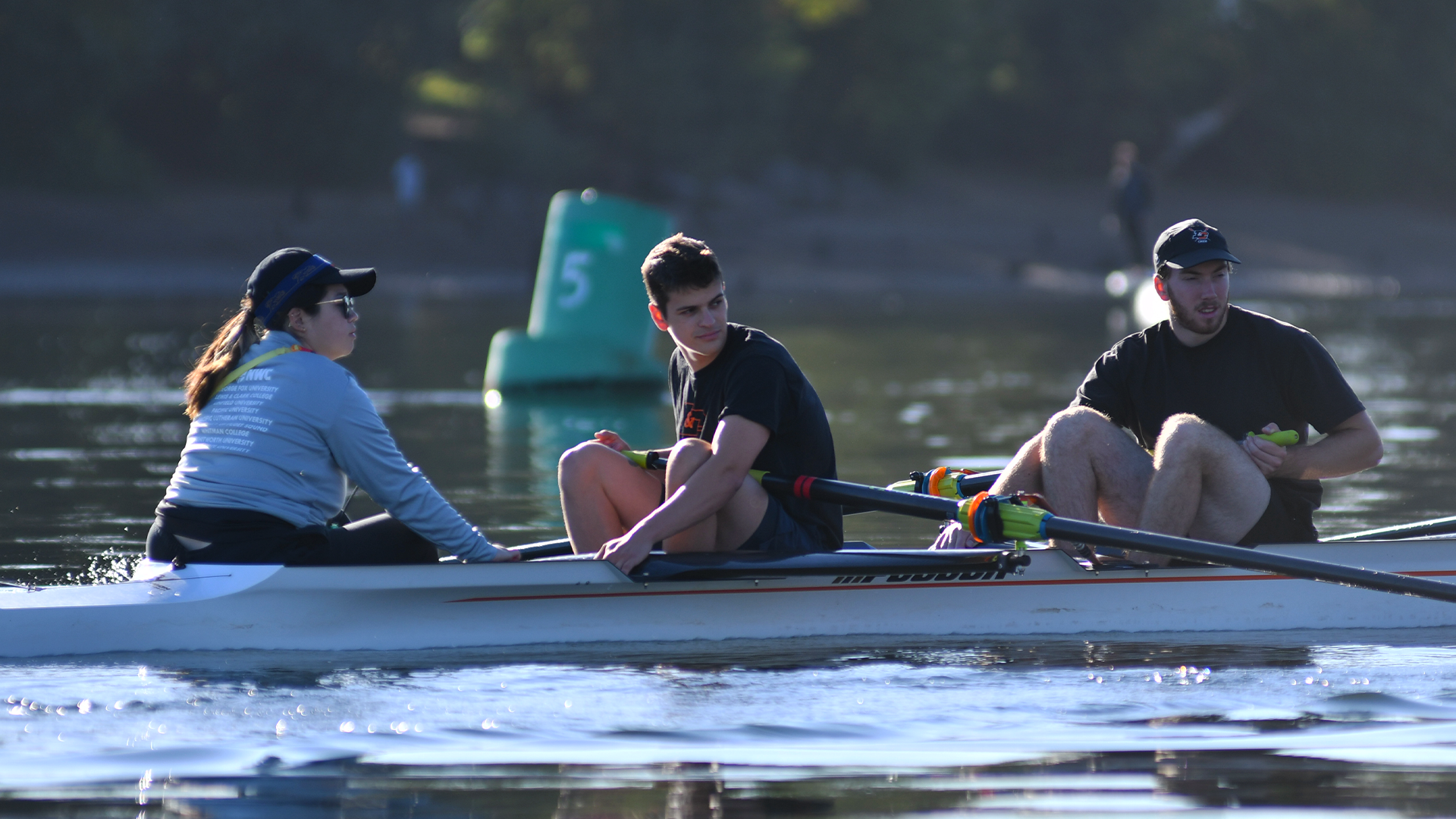 Sophie Homolka, Eliot Woods and Paul Kelly sit in the boat on the Willamette. 