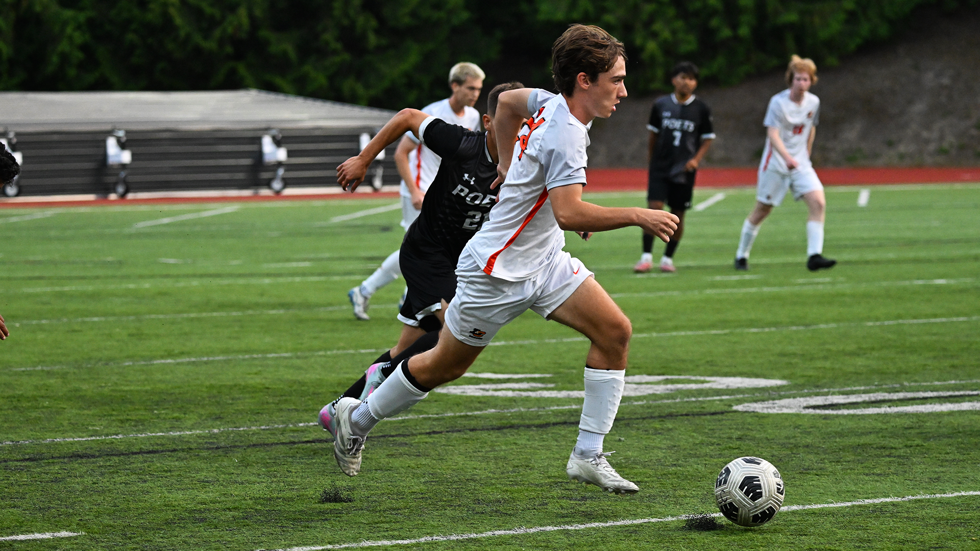 Emmet McDonough runs down the field with the soccer ball. 