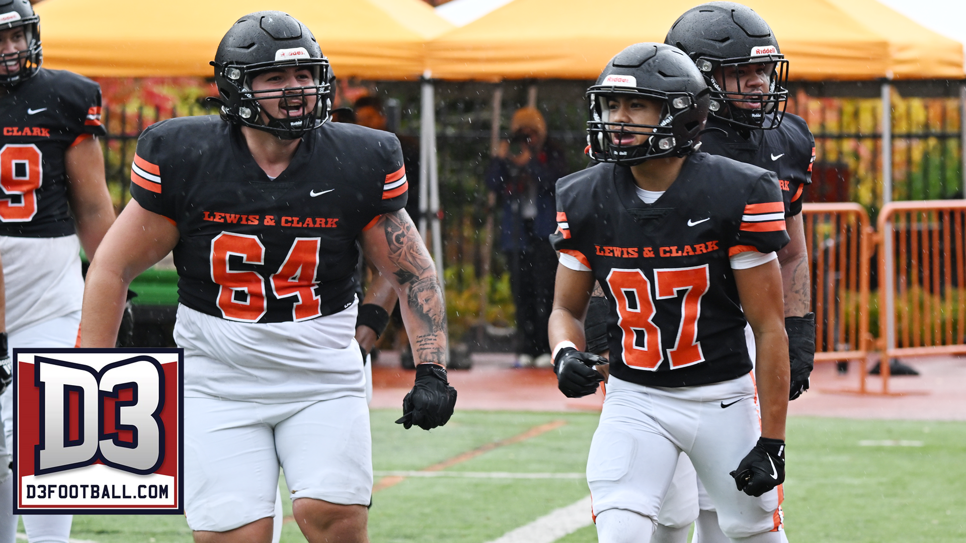 Sytyn Lasconia and Iggy Marquez celebrate Lasconia scoring a touchdown in the rain